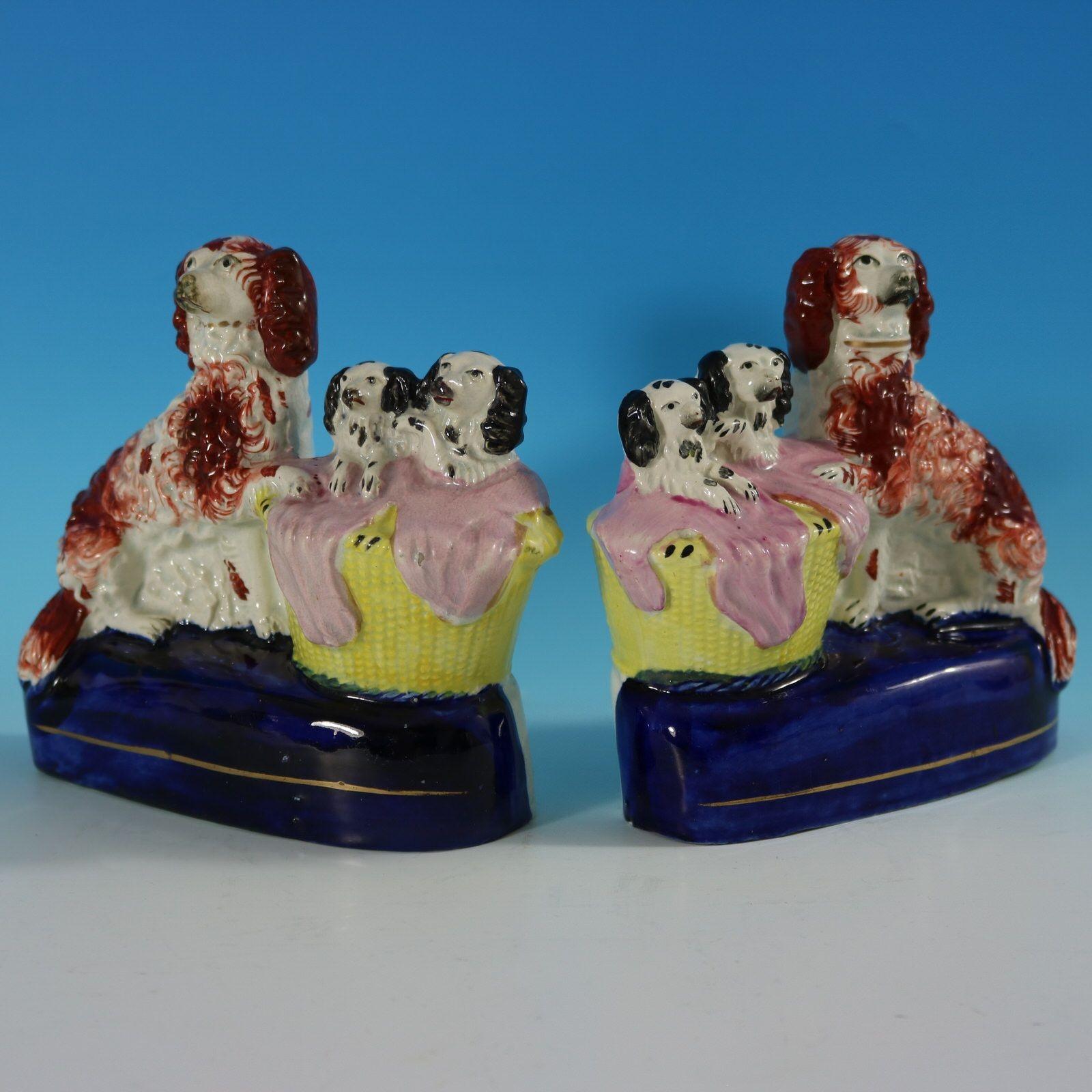 Pair of Staffordshire Pottery groups which feature a spaniel and her pups in a wicker wash basket, seated on an oval base. Dull gilt base line and embellishment. Decorated mainly to the front. Book reference ,'Victorian Staffordshire Figures