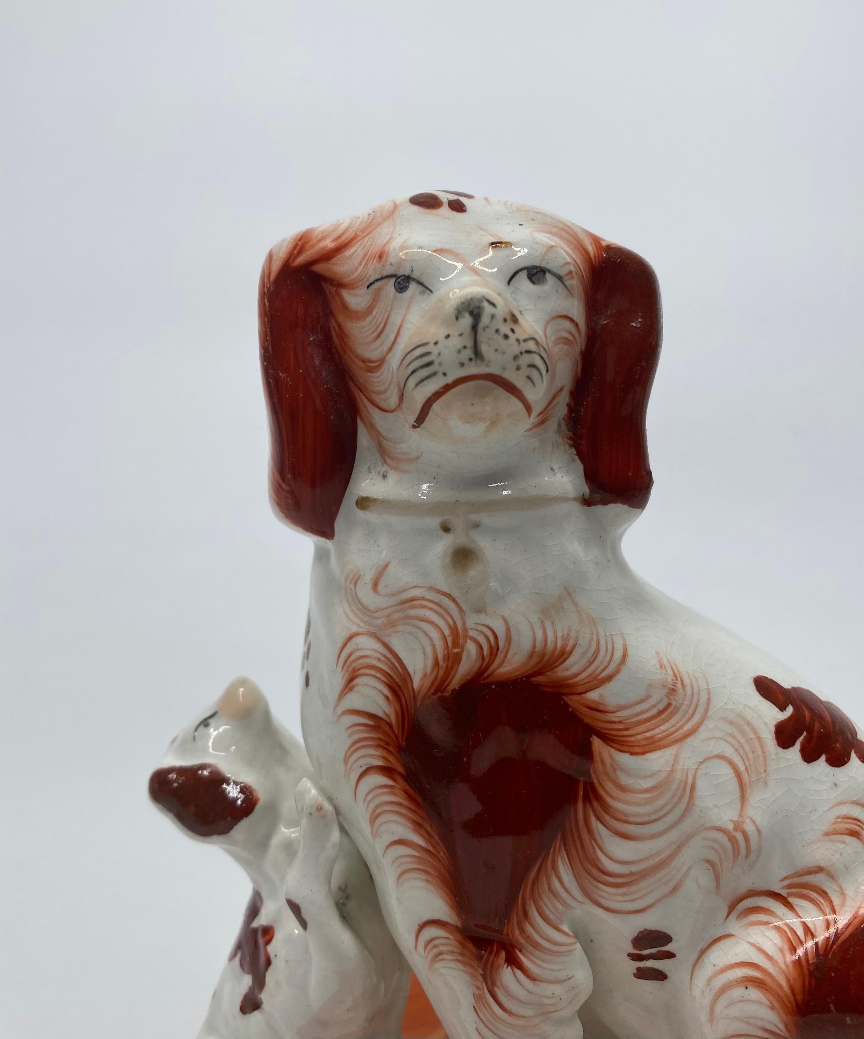 Fired Pair Staffordshire Spaniels with puppies, c. 1850.