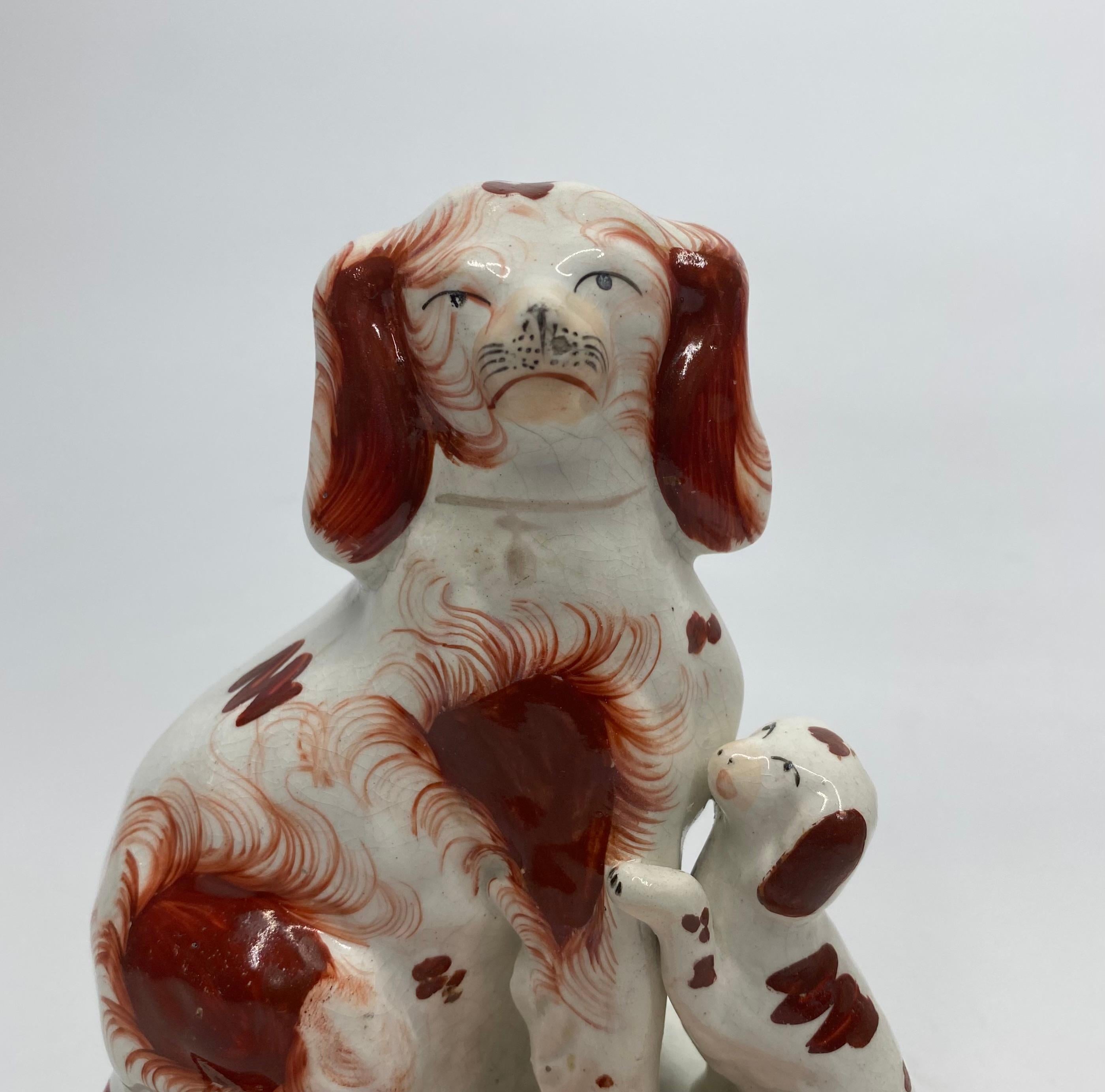 Mid-19th Century Pair Staffordshire Spaniels with puppies, c. 1850.