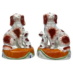Antique Pair Staffordshire Spaniels with puppies, c. 1850.