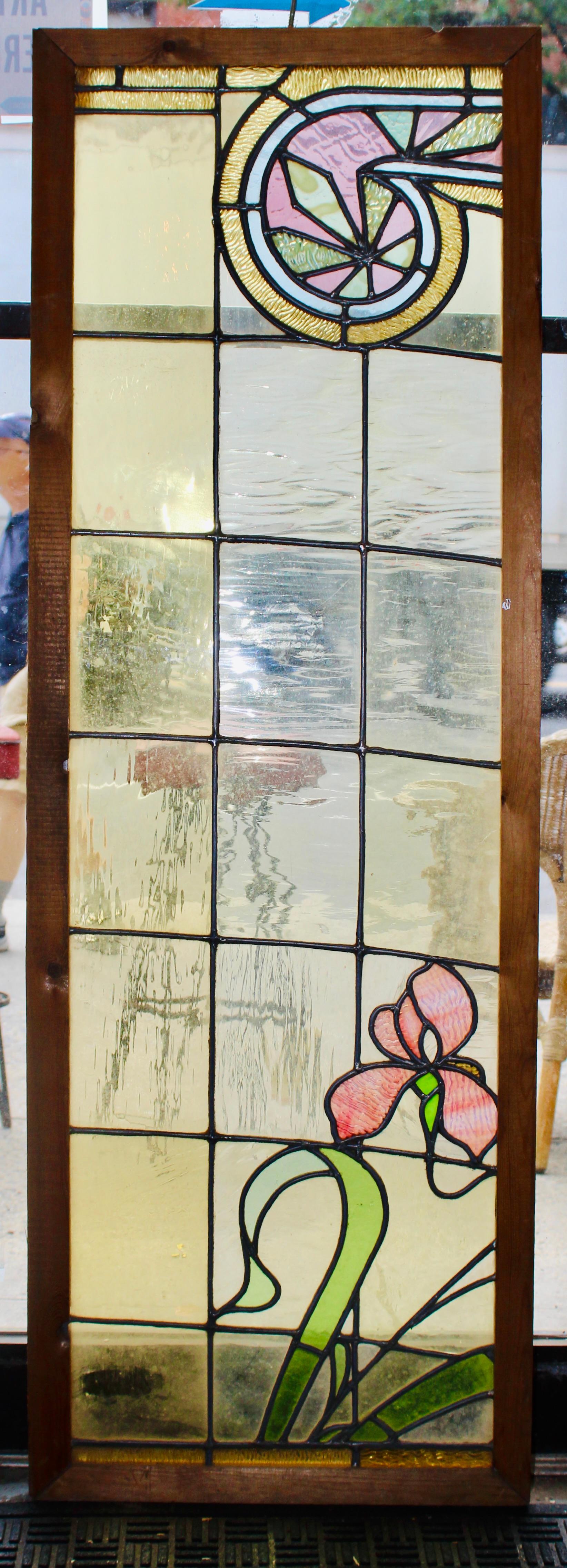 Pair of transom size windows with stained glass. Each window has a beautiful leaded design with a scrolling motif and lily flowers.
Currently housed in a wooden frame - the overall dimensions are for the stained glass and the frame.
Located in NY