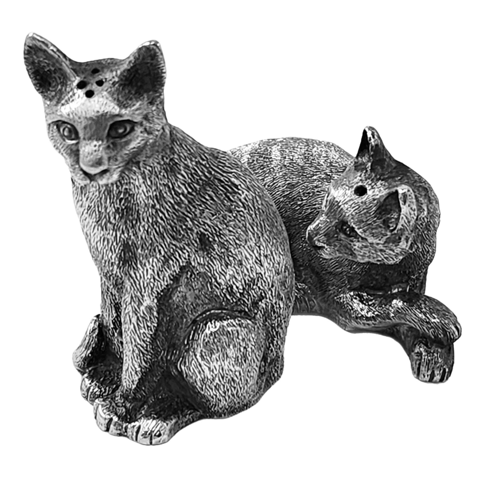 A pair of lovely Sterling Silver Tiffany & Co Salt & Pepper Shakers in the shape of cats. One Cat lounges with its paws crossed and one sits upright. The Cats are modelled with a nice attention to detail and are of substantial weight in the
