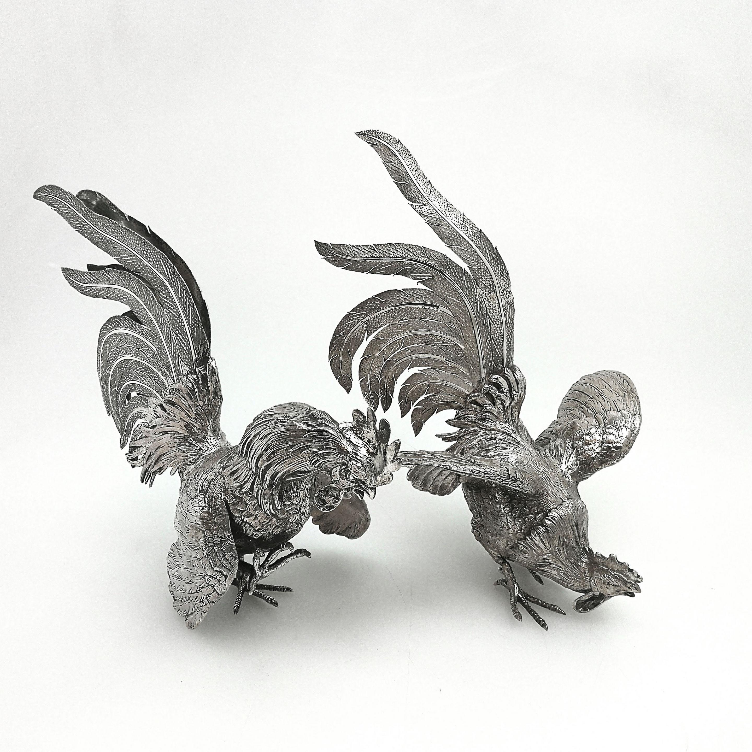 Pair of vintage solid silver table decorations in the shape of cockerels / roosters in an attitude of fighting. These fighting cockerels are created with a wonderful attention to detail with close attention paid to the feathers and plumage. Both