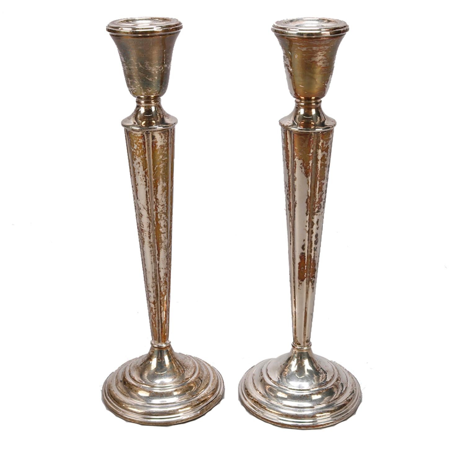 A vintage pair of pillar candle sticks by Lunt over weighted sterling silver construction with maker mark on base as photographed, circa 1940

Measures - 10