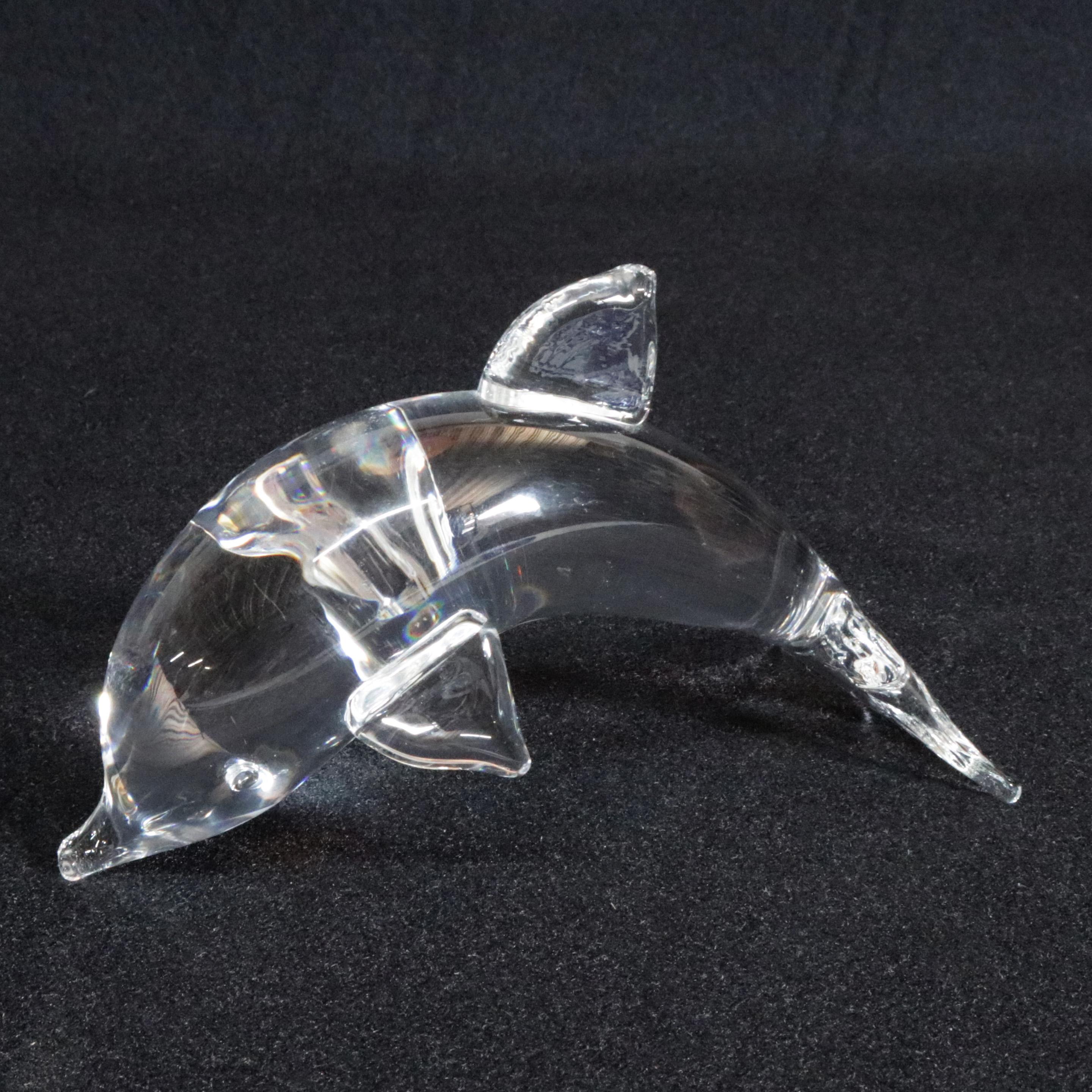 Pair of midcentury Steuben figurative mouth blown crystal sculptural paperweights of features colorless art glass in full body form of dolphins (porpoise) designed by Lloyd Atkins 1984 for Corning Museum of glass, New York, NY, signed on base, 20th