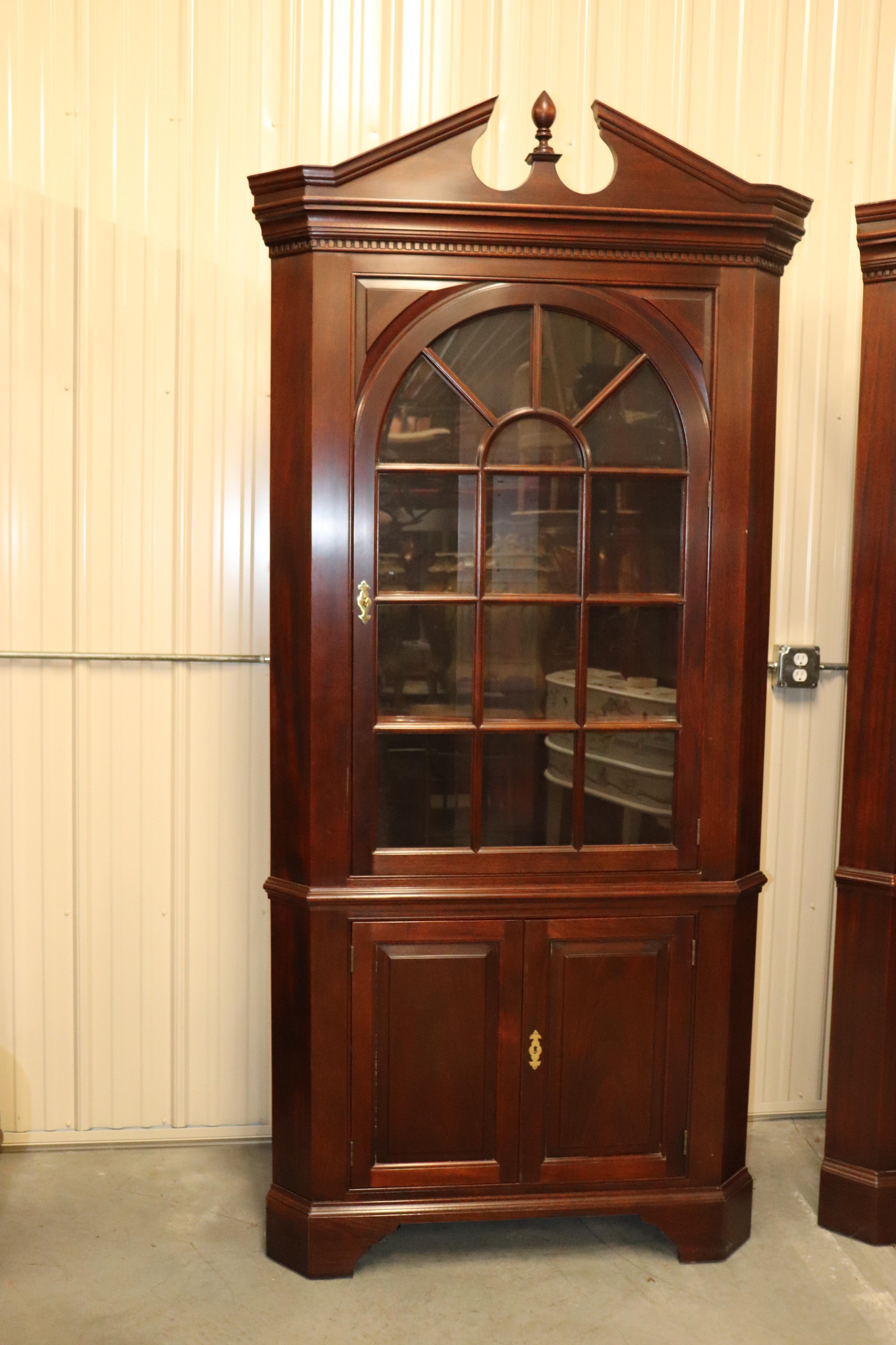 This is a very clean pair of solid mahogany corner cabinets by Stickley furniture. They feature incredible wood quality and are in superb condition. The glass is all individal and these are perfect for your client's home where they need a high