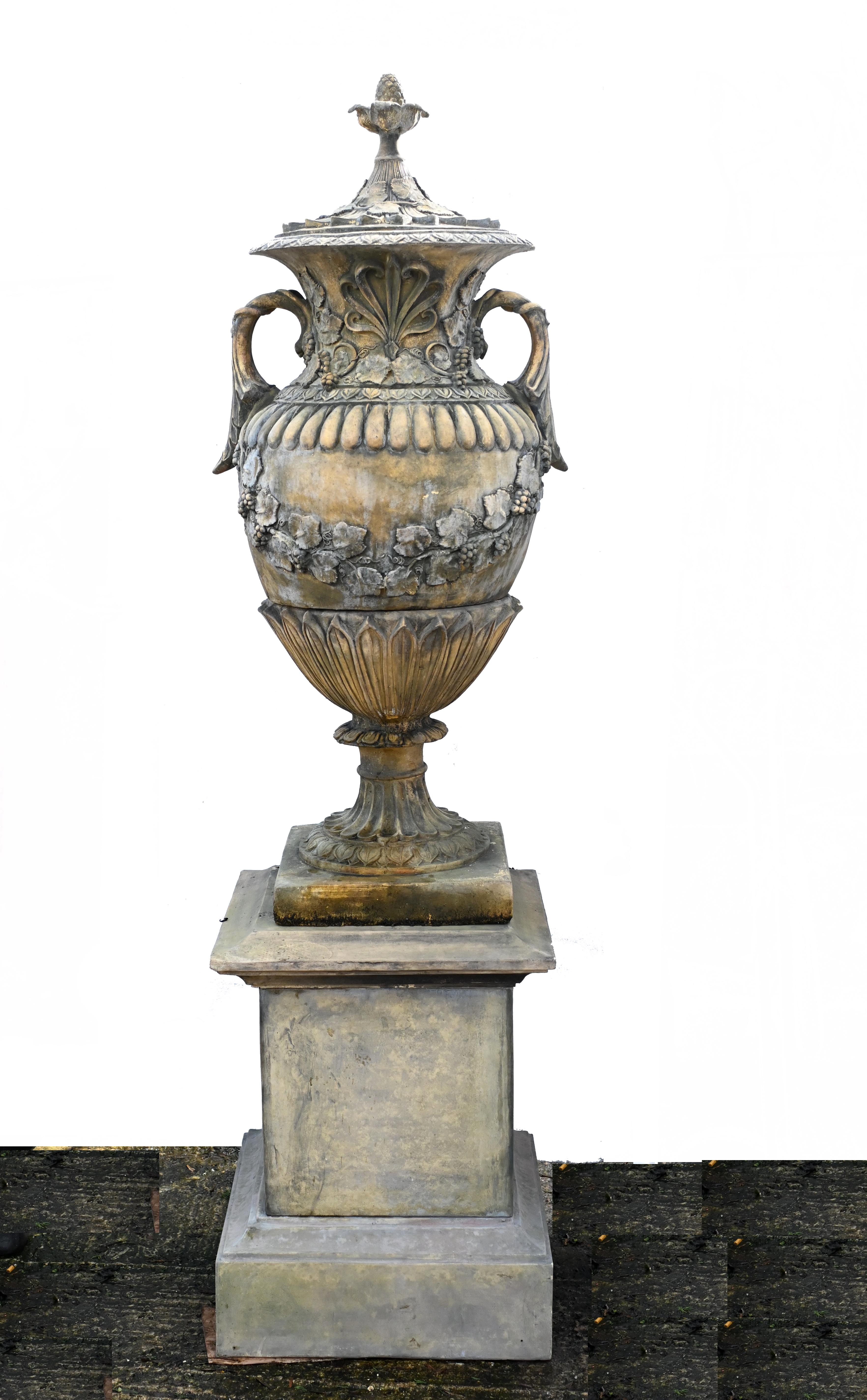 Stunning pair of large English stone garden urns of amphora form
Stand on the square pedestal bases
Overall height is eight feet tall - 243 CM - so good size 
The urns come in three parts and also are separate to the square pedestal bases
Wonderful