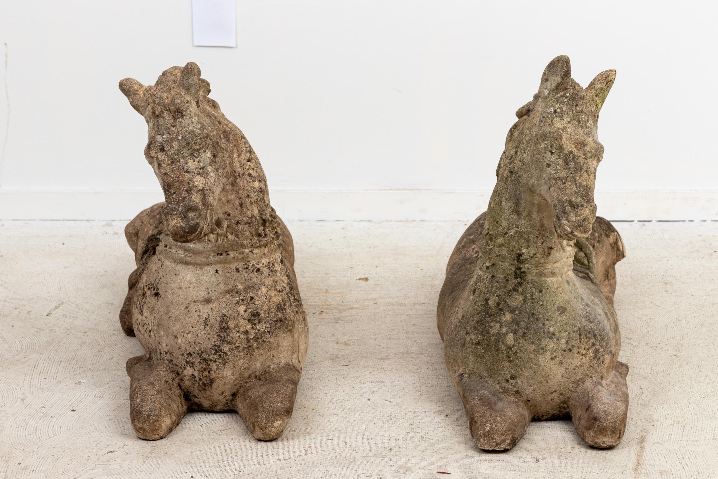 Pair of early 20th century cast stone horse. Substantial in size, the horses mirror each other in form.
