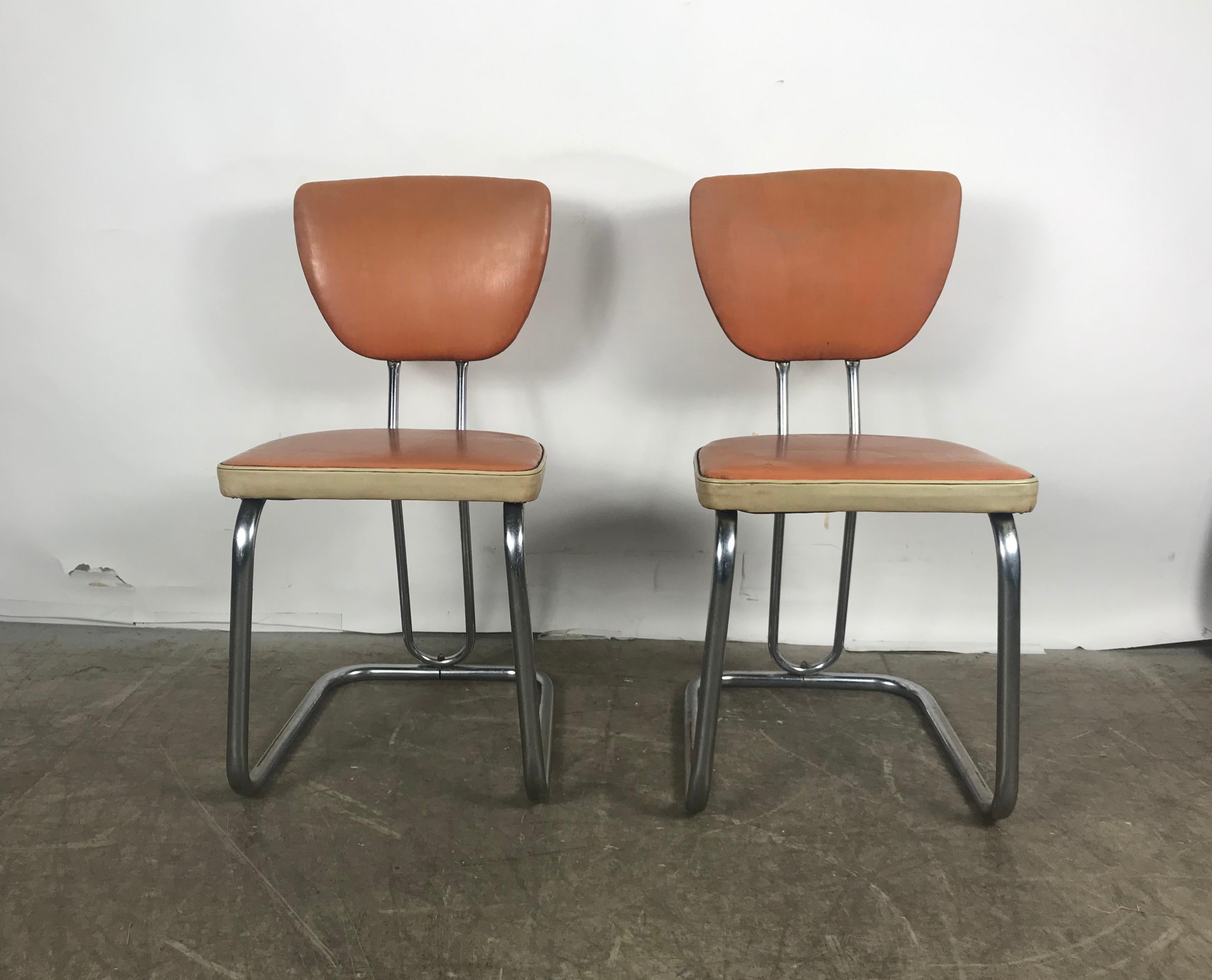 Pair of stylized Art Deco, Machine Age tubular chrome side chairs by Daystrom. Amazing design. attributed to Walter Dorwin Teague. All original, retains original two-tone early oil cloth (naugahyde) fabric seat and back, extremely comfortable.