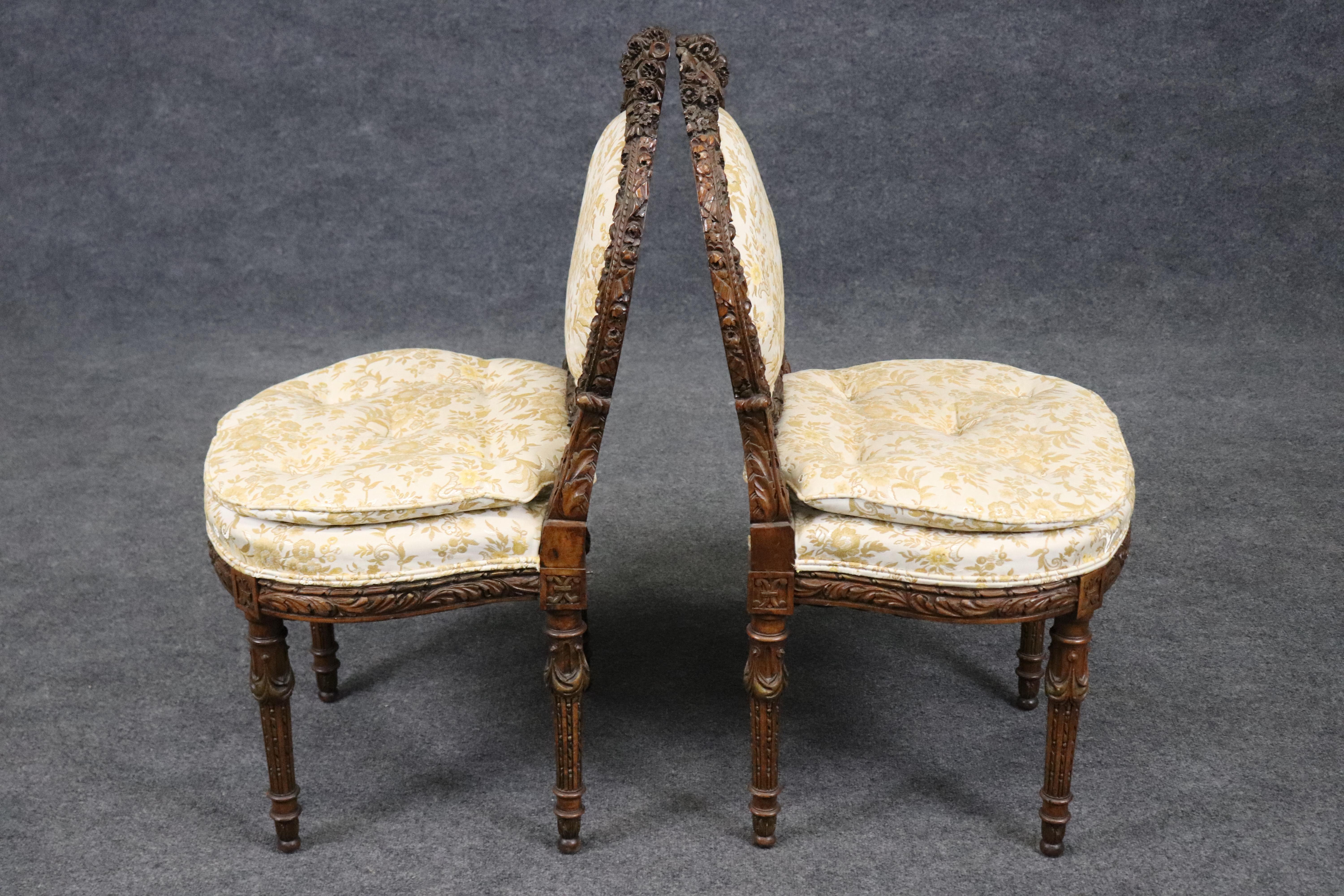 This is a gorgeous pair of ornately carved walnut boudoir chairs. These chairs can of course be used in any area of your home and not just the bedroom. The chairs feature amazing carving. The chairs are in good condition with signs of age and a