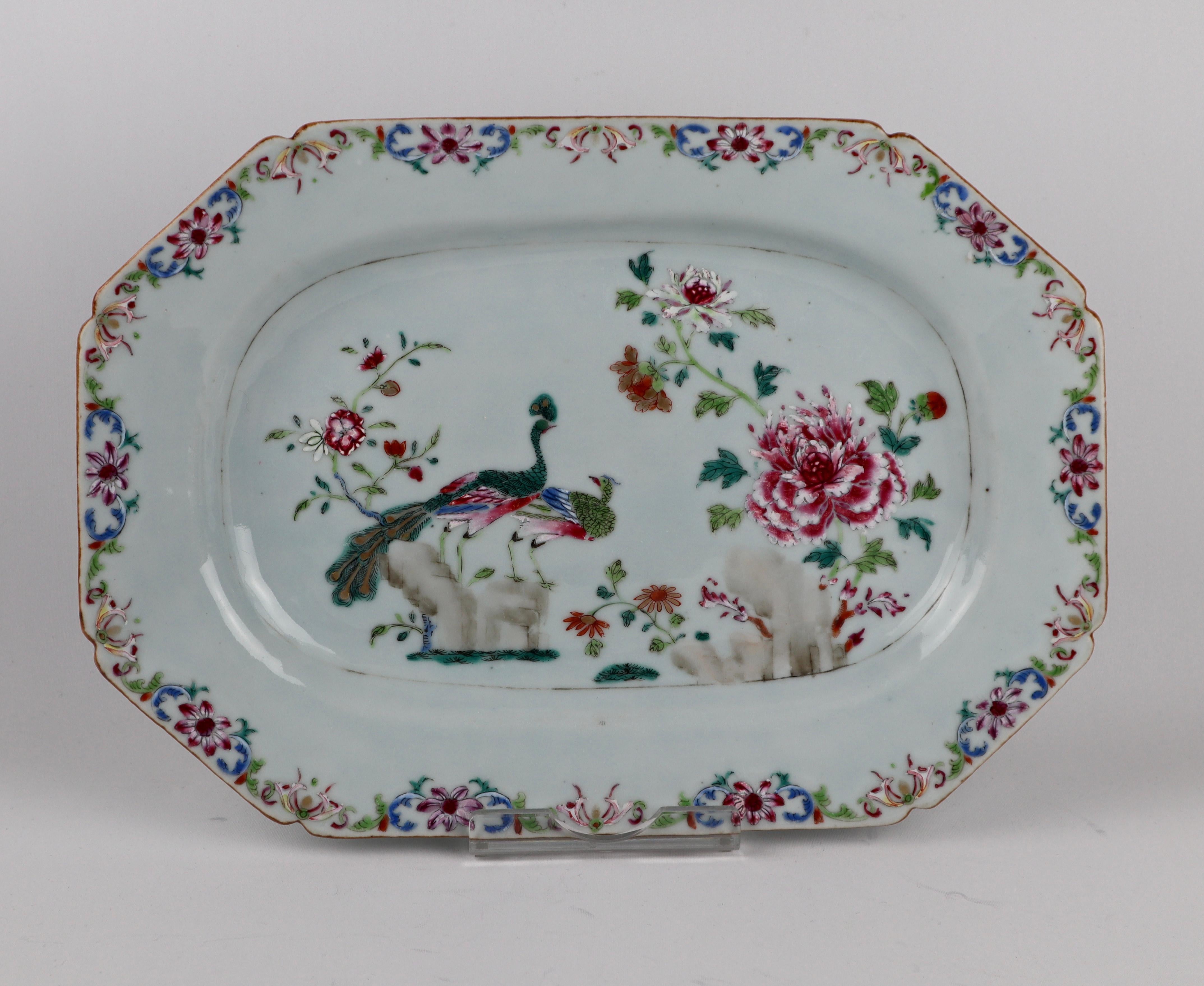 A Pair of Chinese famille rose 18th century Porcelain double peacock Platters. Qianlong 
Hand painted in the classic pattern showing a peacock and peahen perched on rockwork in a garden growing with large, lush peony blooms alongside smaller