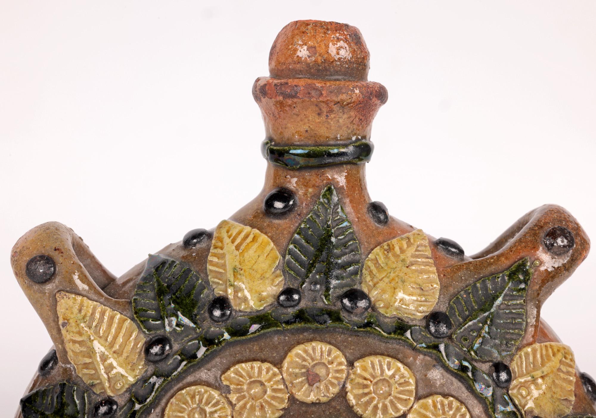 Ein sehr stilvolles und handgefertigtes Paar Pilgerflaschen aus Keramik mit Blumenmuster, das möglicherweise aus Sussex, England, stammt und auf das 19. Jahrhundert datiert wird. Die leicht getöpferten Gefäße aus roter Terrakotta haben eine runde