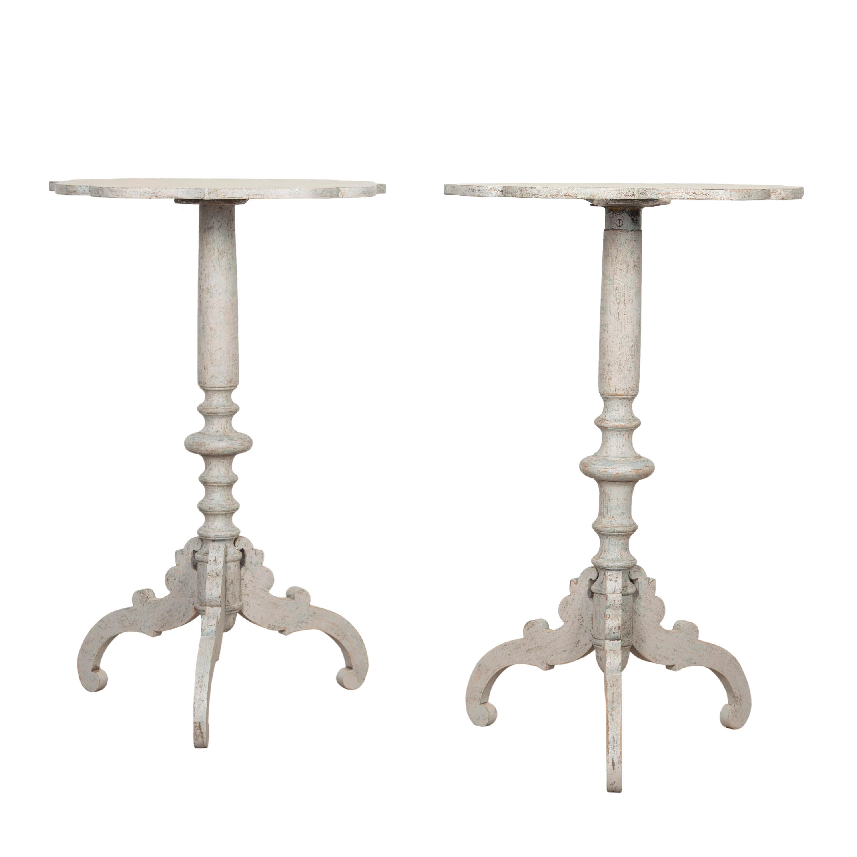 Pair of Swedish 19th Century tables. These wonderful tables have decorative tripod bases and stems which have been wonderfully turned to represent columns. Both have decorative tops with slightly scalloped edges! 
They have been re-painted with a