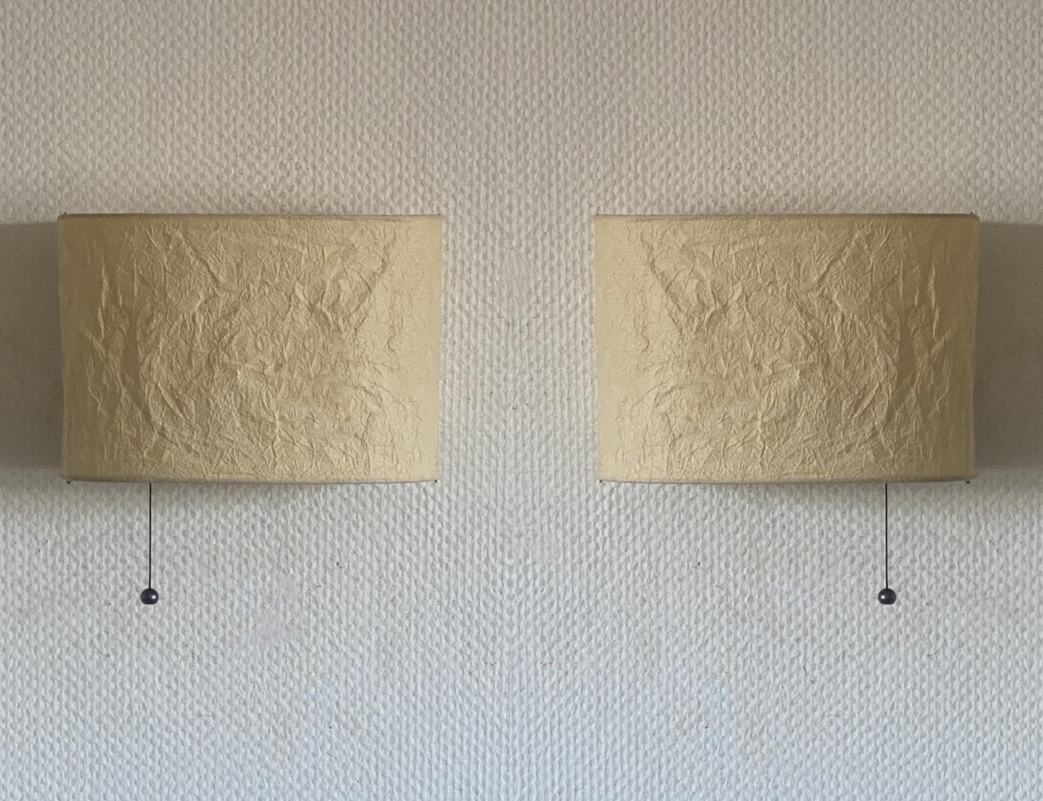 A Pair of rare swedish design wall lights of parchment paper and metal wall, Sweden, 1980s. Both sconces in fine vintage condition, no damages. Each sconce takes one E27 screw base lbulb.
Dimentions:
Width 12