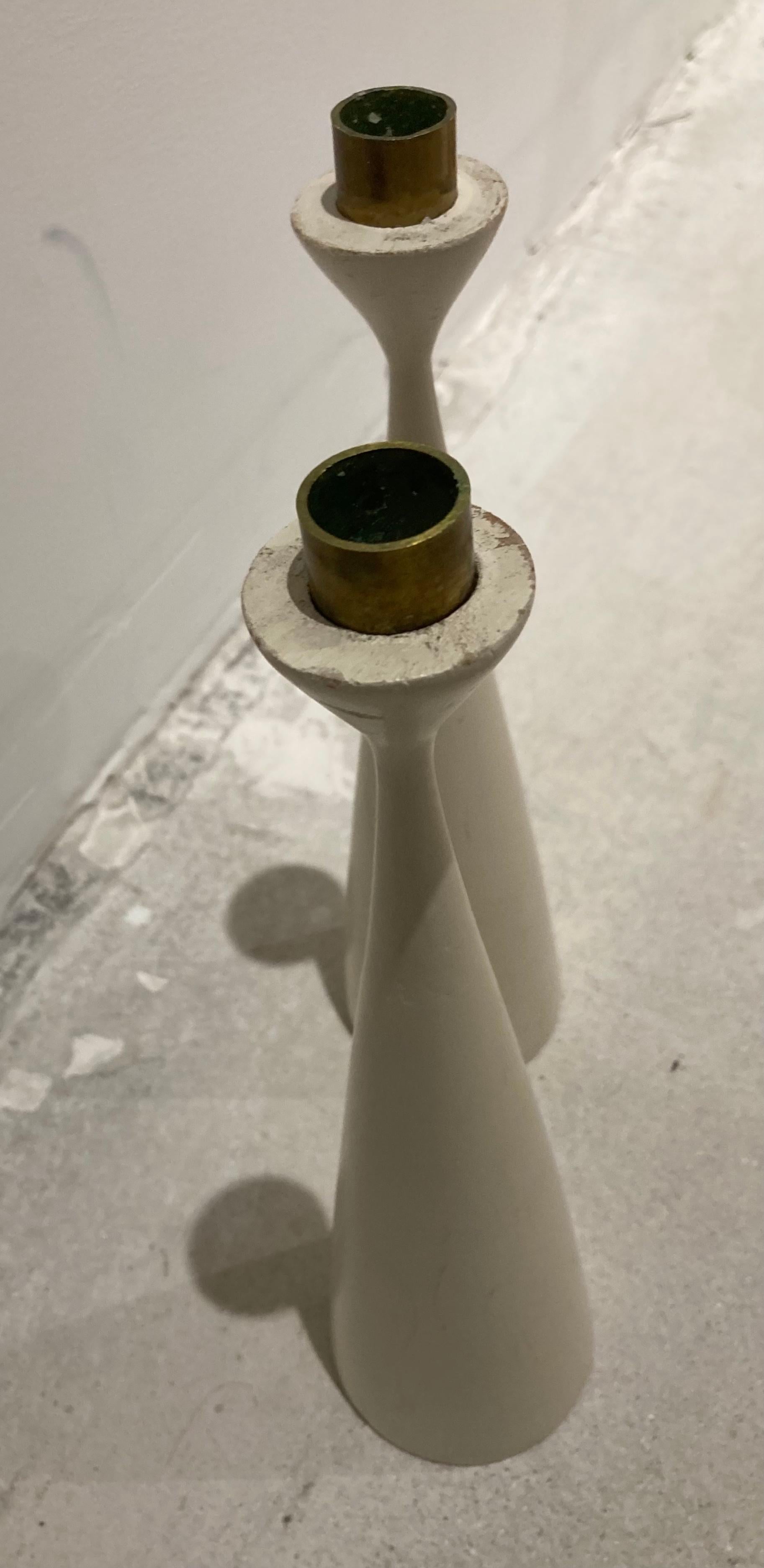 Pair Swedish designer modern wood painted white candlesticks. Brass nozzles.

Marked 