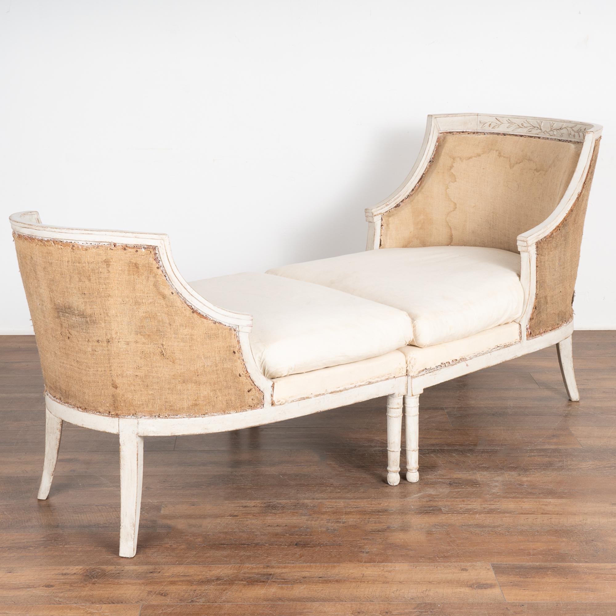 This lovely pair of Swedish chairs is a rare find; when placed together, they create a unique sofa or settee. They were likely commisioned as a one of a kind set when they were crafted. The two chairs are designed to fit together with both concave
