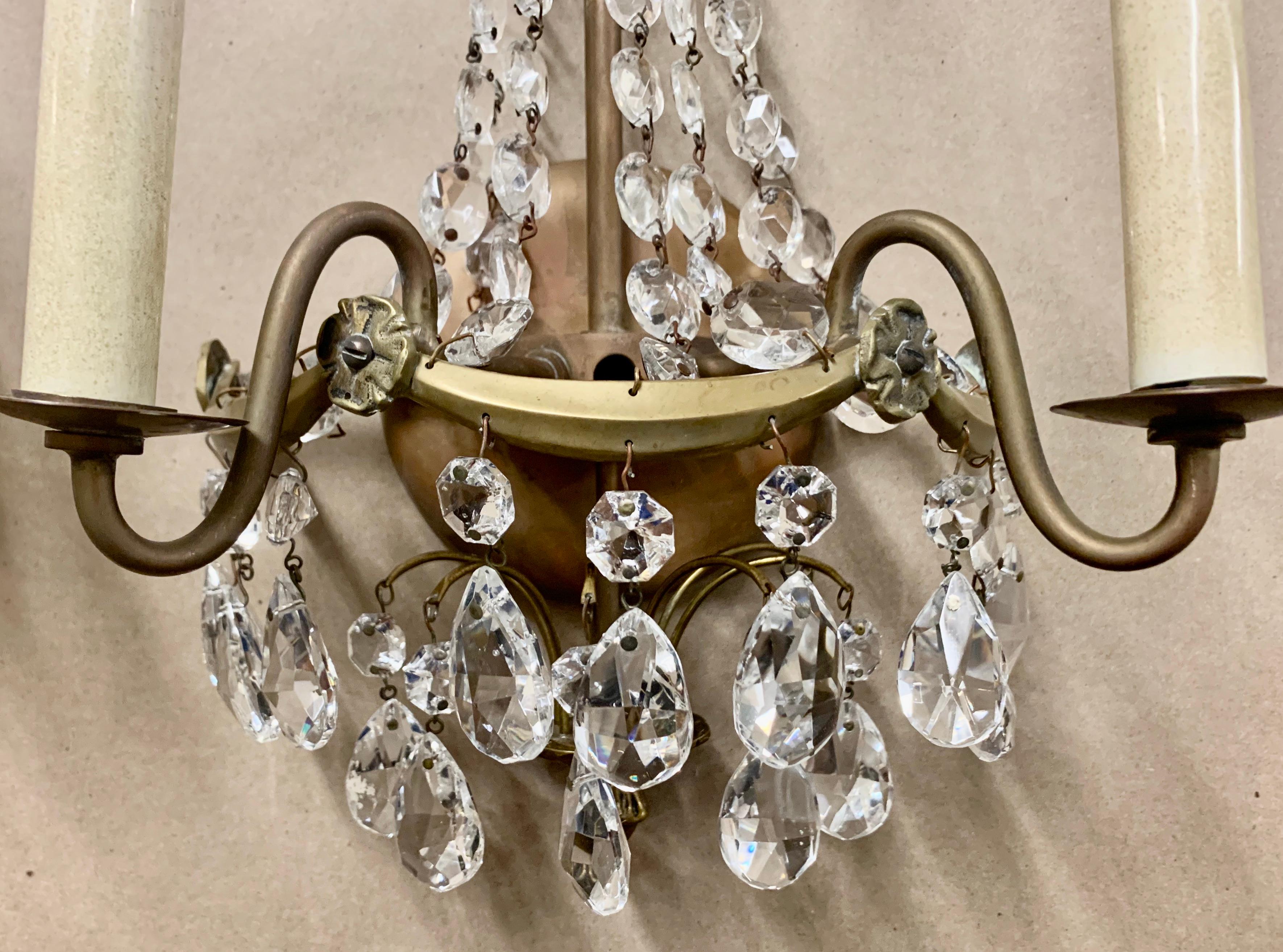Pair of Swedish Gustavian (neo-classical) two light sconces. The frames are bronze hung generously with faceted crystal drops. There are six arms above and below with faceted crystal teardrops. There are also swags of faceted beads from the top to