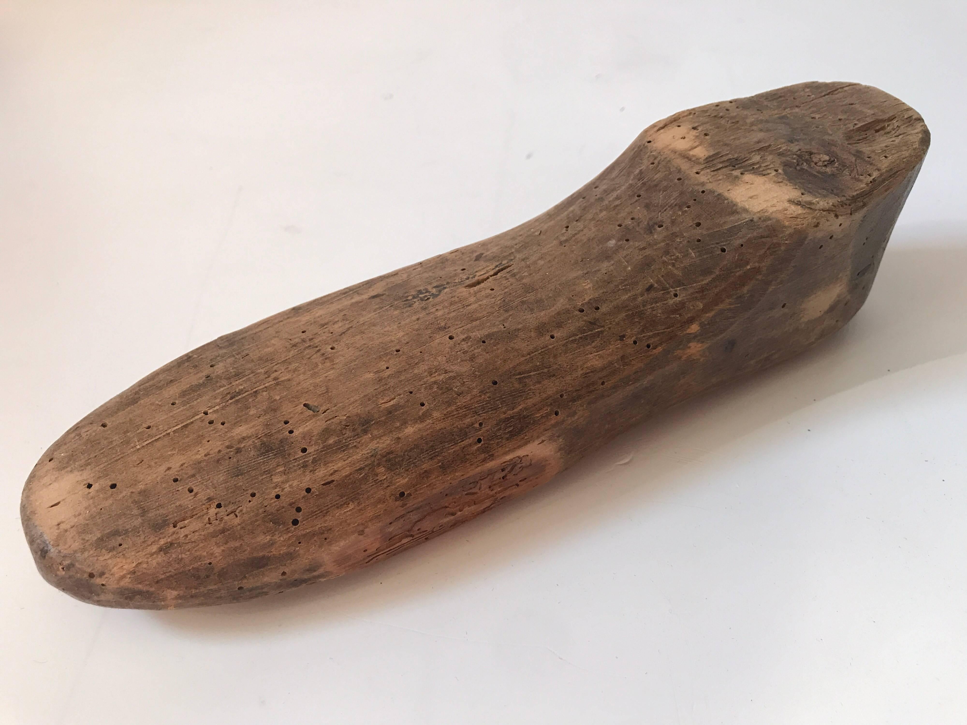 Pair of Swedish hand-carved antique shoe molds, 19th century.
A rare pair of hand-carved shoe molds from the 19th century, made in Sweden. The biggest measure 28 cm and the smaller one is 26 cm long. There are worm holes and some chips, but that is