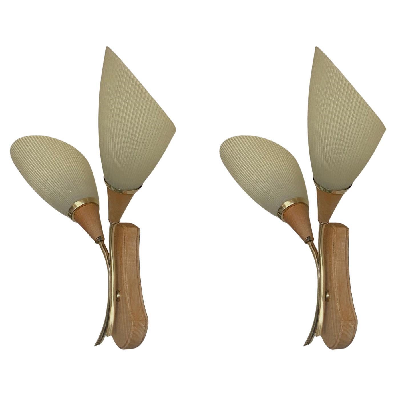 A pair of lovely pine, brass and art glass two-light wall sconces designed and produced in Sweden in the 1940s. Clean lines and organic design from the Scandinavian Modern period, two-arm with beautiful glass pleated shades. Both sconces in very