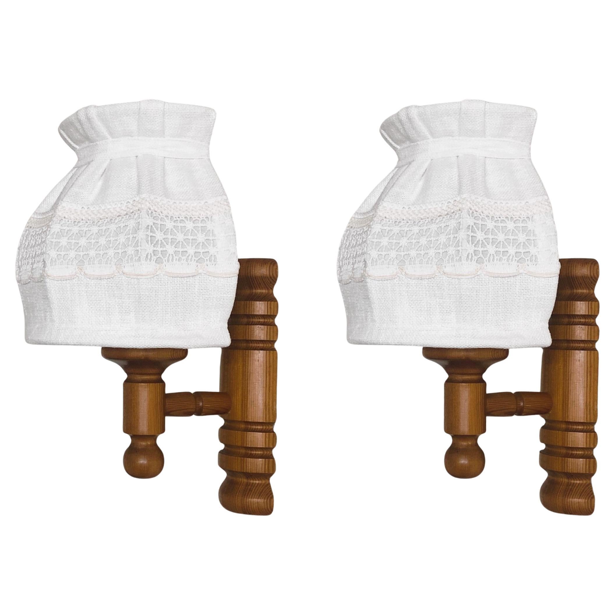 Pair of lovely pine wood wall sconces designed and produced in Sweden in the 1960s. Clean lines and organic design from the Scandinavian Modern period, with off-white lampshades and pull switch with cord that can be easily removed if you want to use