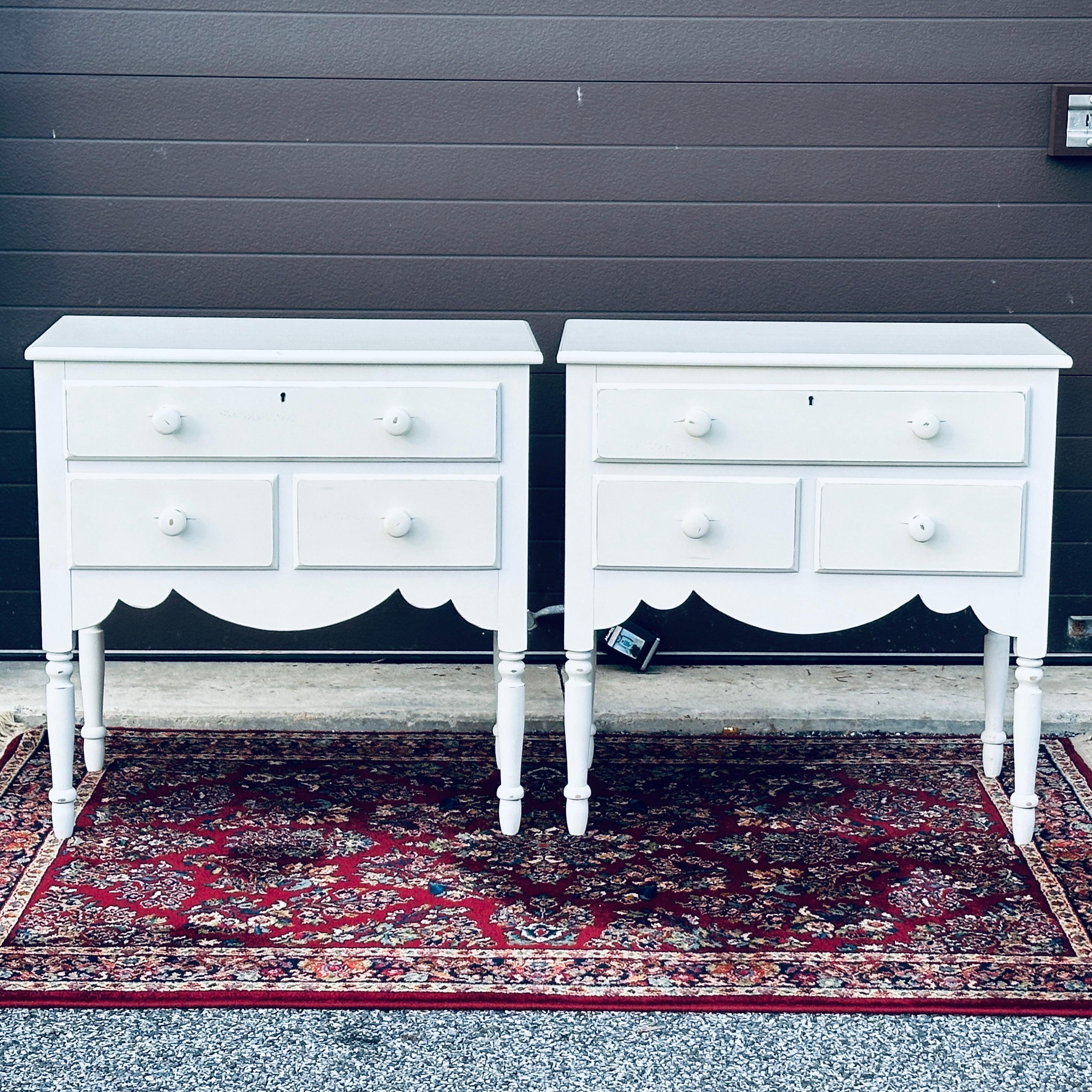 Nice pair of Swedish style three drawer commodes or nightstands by Lexington Furniture. These are marked in the drawer and back and in very good condition with intentional factory distressing to the off-white painted finish. 