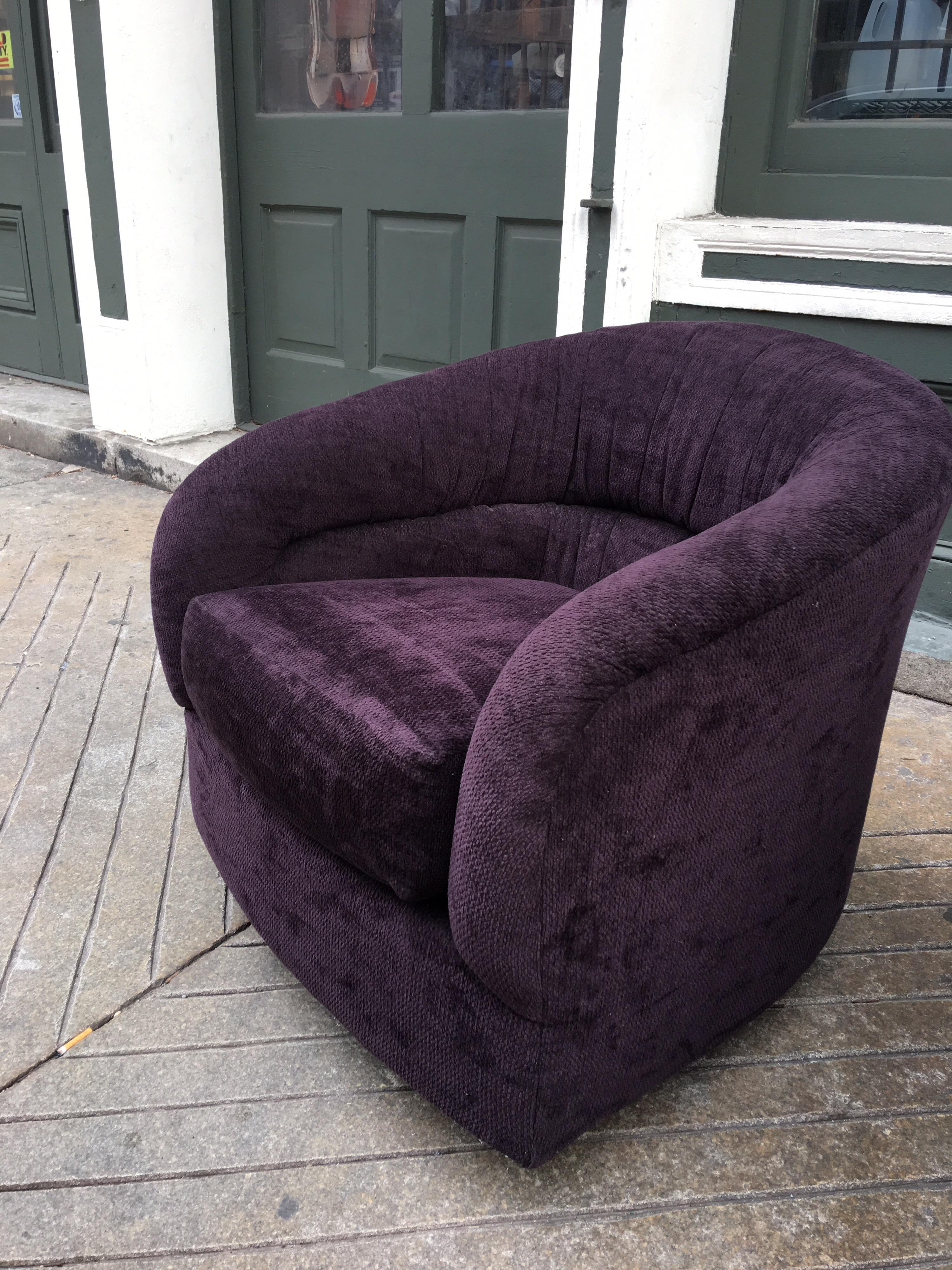 Pair of swivel barrel chairs in a plum fabric. Both chairs swivel and one has the extra feature of rocking! Very comfy rounded back chairs!
