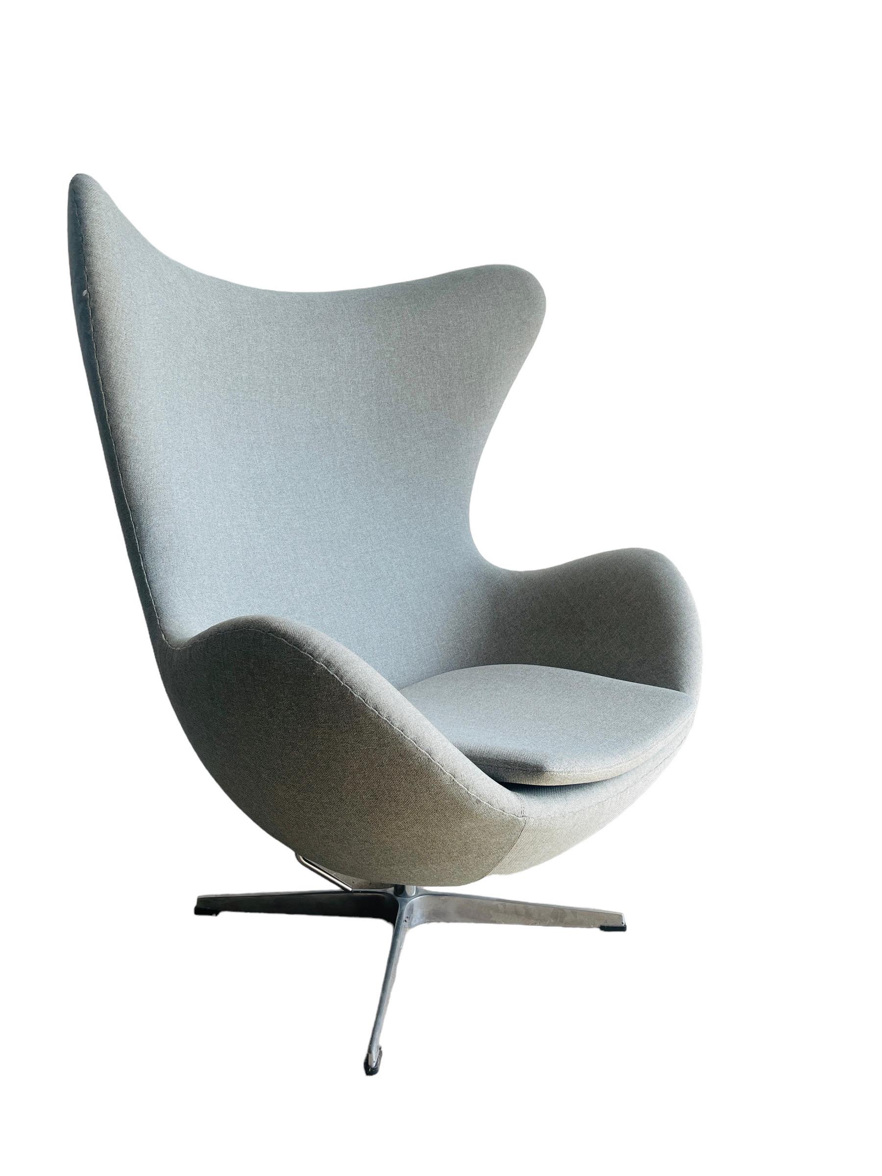 For sale is a pair of elegant modern Egg Chairs, exemplifying sleek design and comfort. These chairs are in excellent condition, free from rips, stains, or damages, making them a superb addition to any contemporary living space. Each chair measures