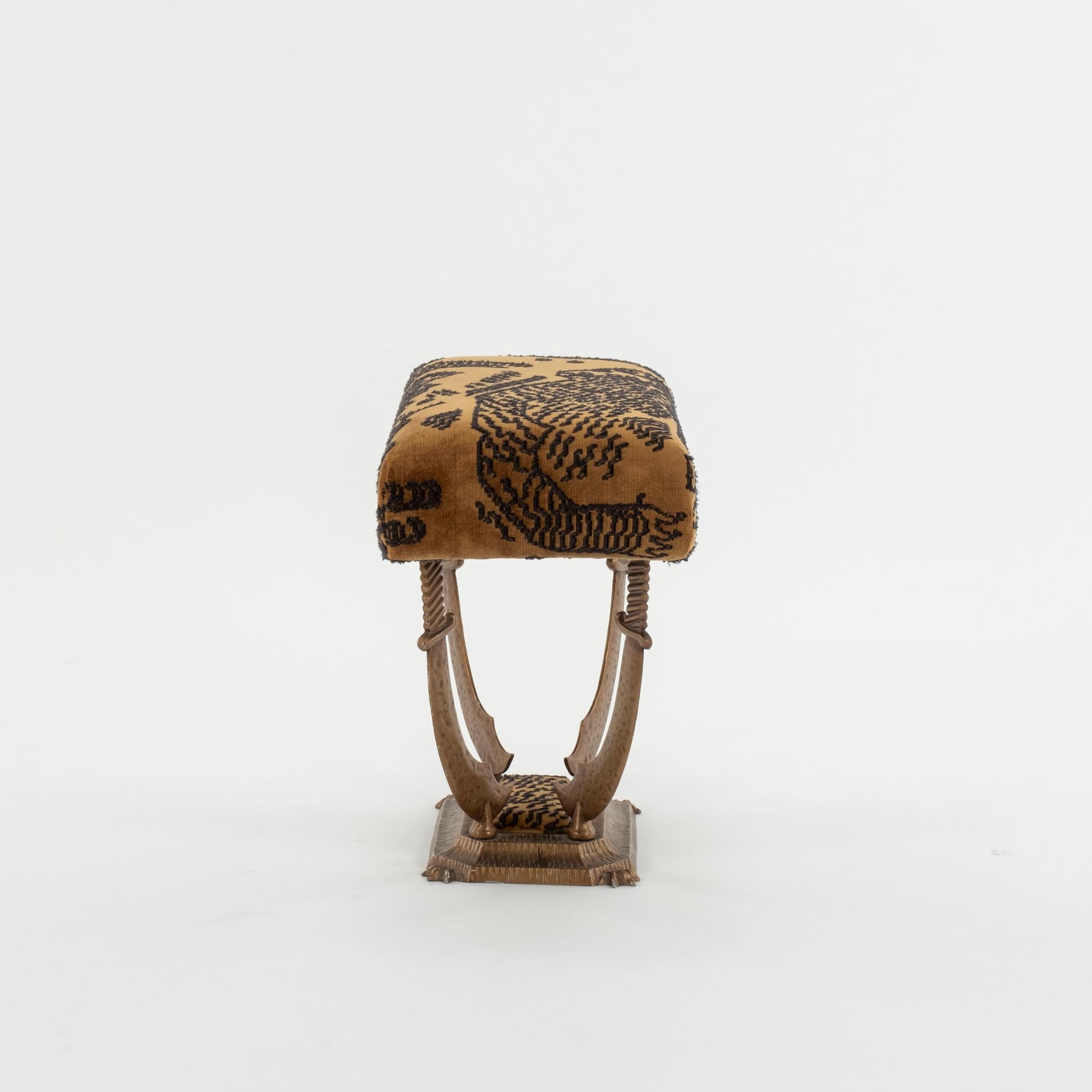 Pair of Hollywood Regency sword tabourets newly upholstered in Dedar Tiger Mountain fabric.