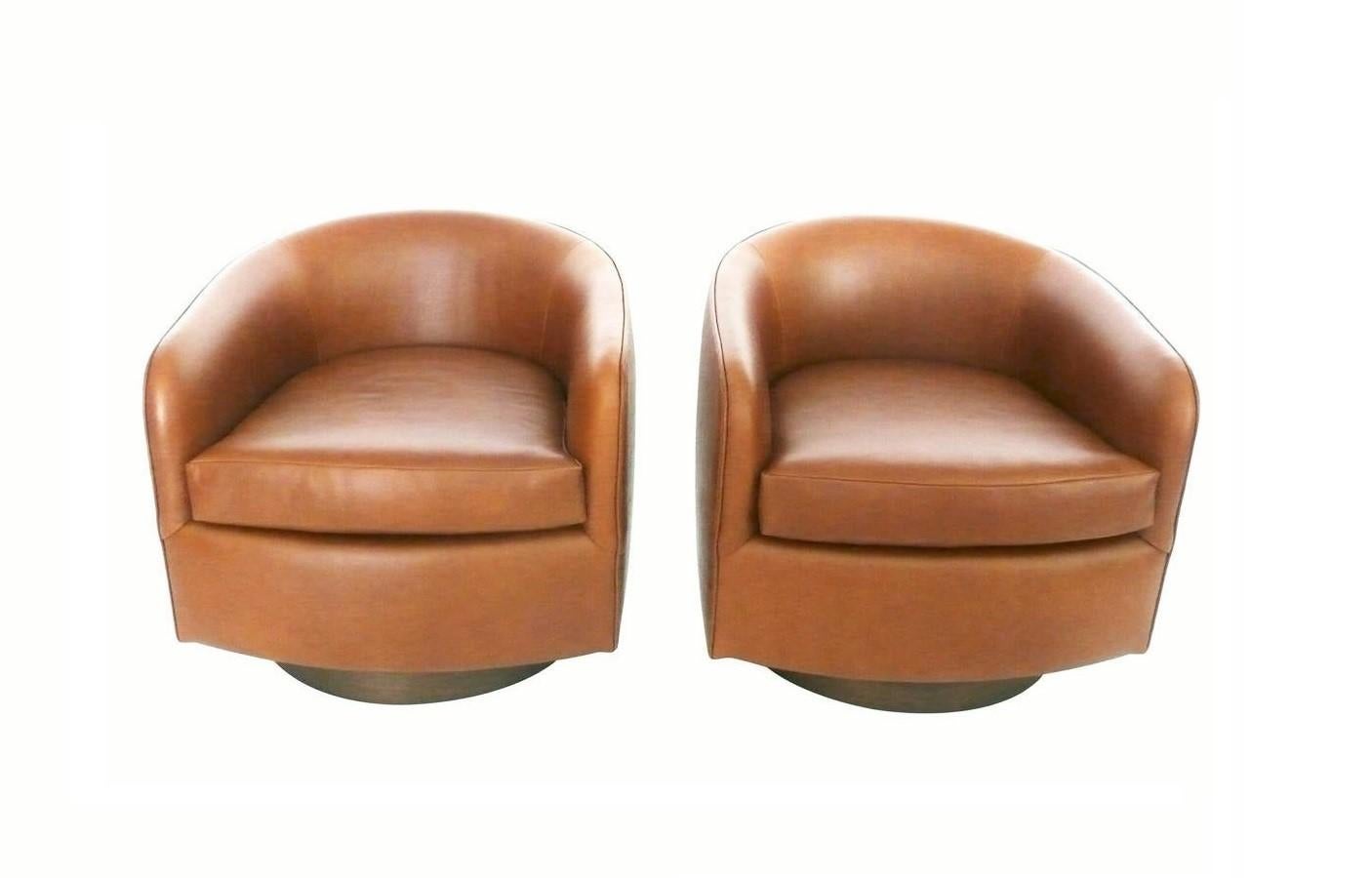 We love these chairs because of their style, comfort and the swivel. These Milo Baughman for Thayer Coggin tub chairs are a modern classic. Featuring a rouned back, even arm, tilt and swivel maple wood bases. Chairs are freshly upholstered in a