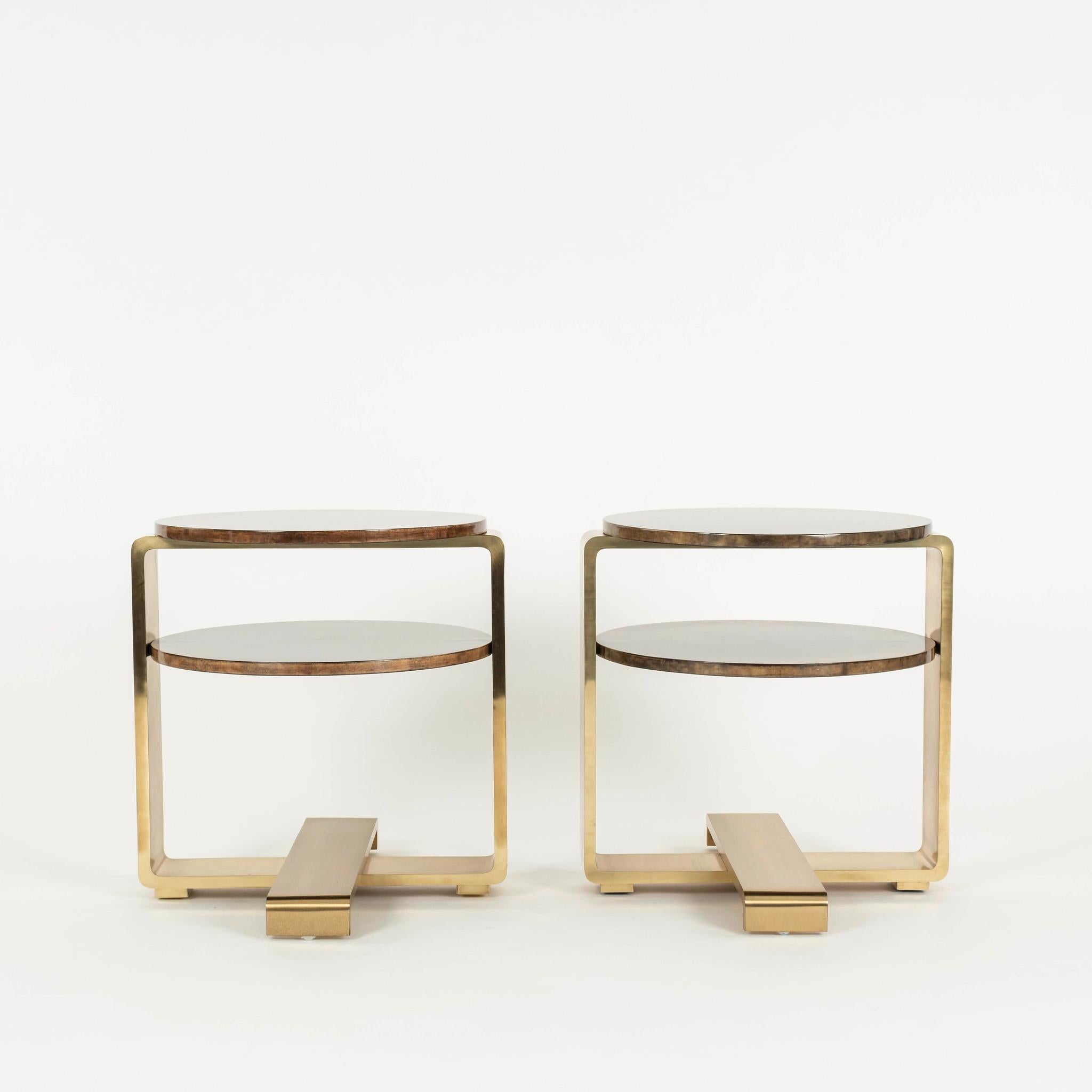 A chic and stylish pair of lacquered polished brass andf goatskin occasional tables handmade by luxury brand Sylvan S.F.