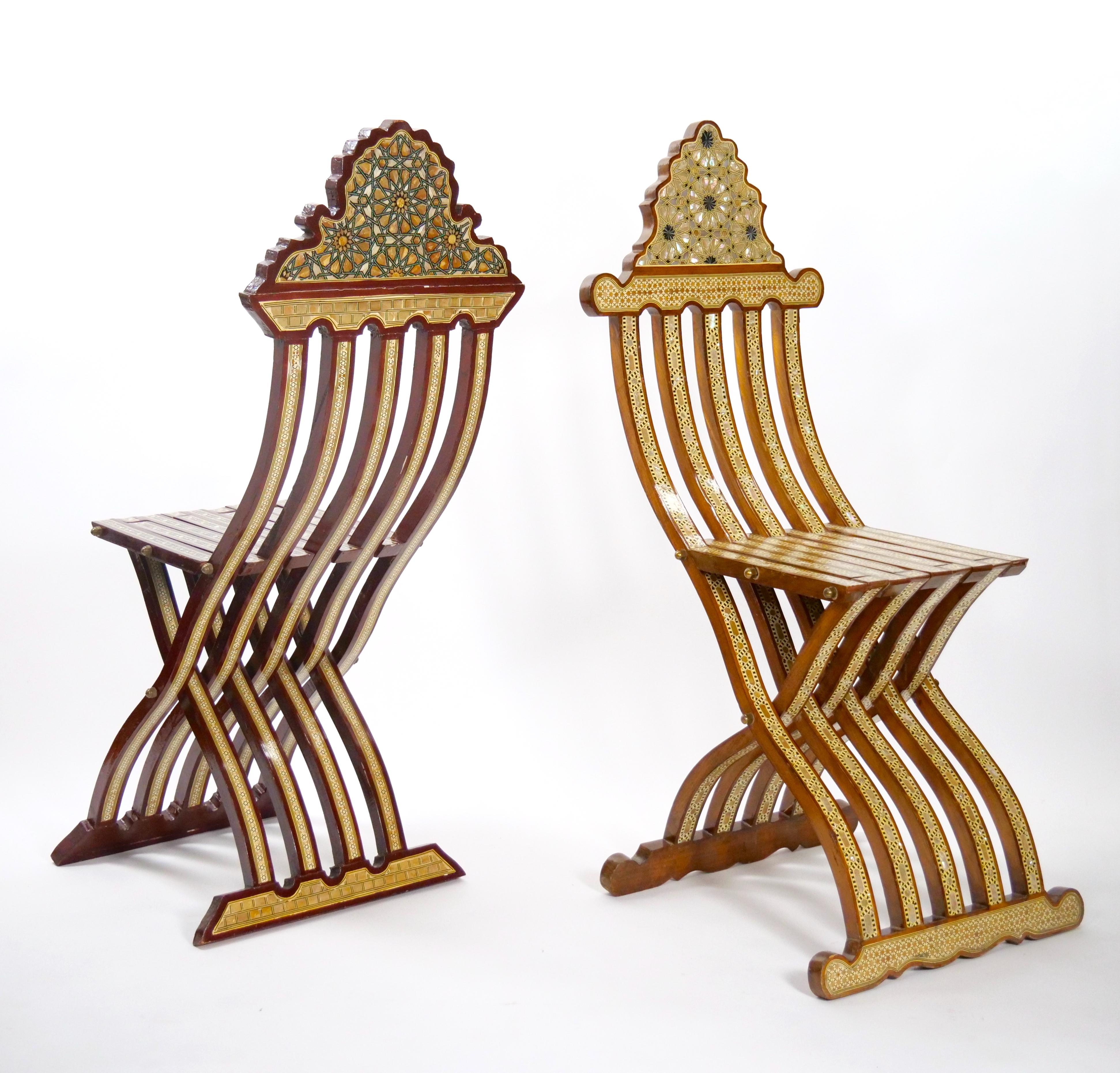 Introducing a refined near pair of late 19th-century antique Syrian carved walnut folding scribe chairs. These classic and elegant chairs are a testament to the exquisite craftsmanship of the era, showcasing hand-carved walnut in a folding slat