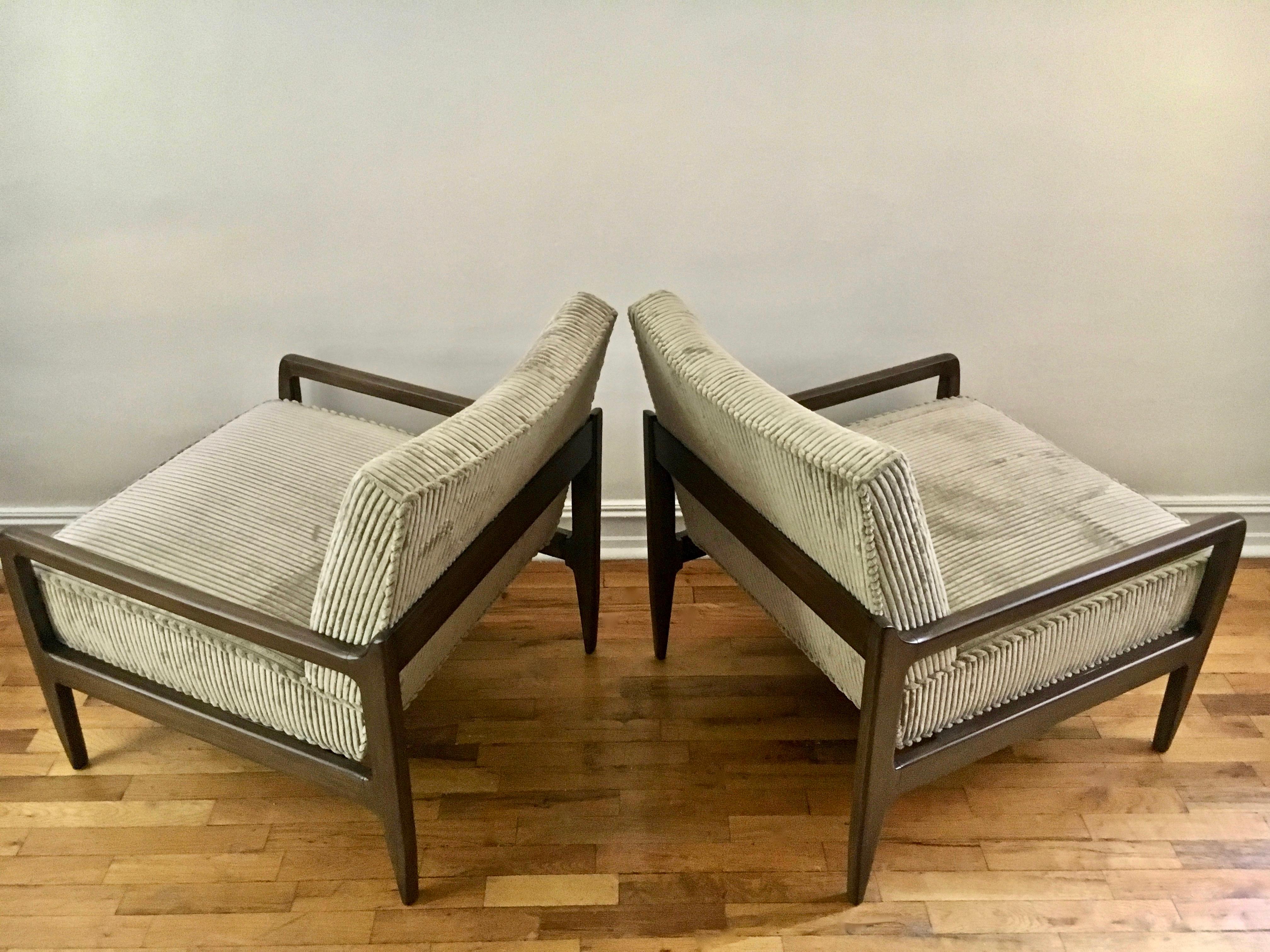 American midcentury pair of Robsjohn Gibbings style walnut lounge low profile armchairs. Featuring a sturdy, solid hand grained walnut frames with slightly angled ergonomic single cushions reupholstered in pale sage wide whale corduroy. Classic.