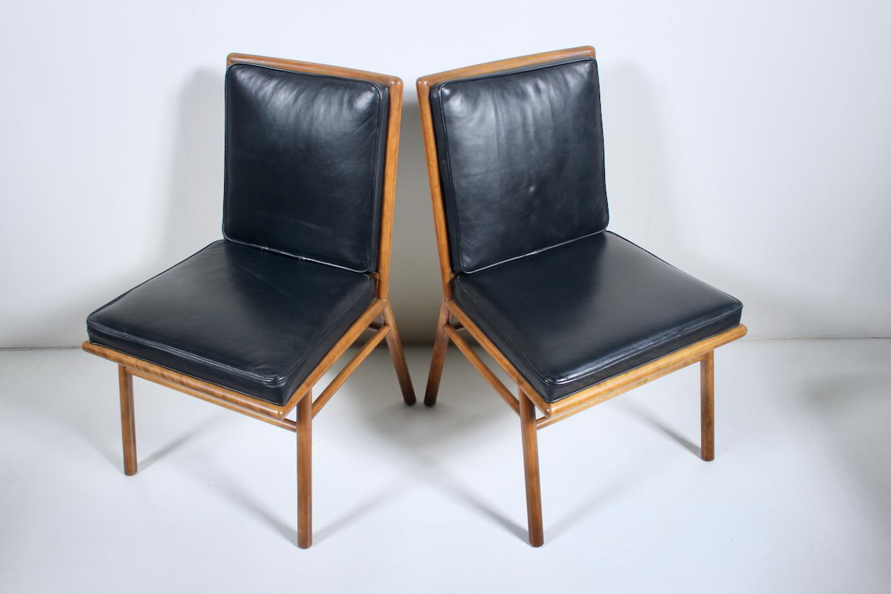 Pair of T.H. Robsjohn-Gibbings for Widdicomb Maple & Black Vinyl Side Chairs. Featuring sturdy, solid turned dowel balanced framework, cushioned Black Vinyl upholstered seat and backs with Black vinyl detail to rear. Classic. American Mid Century.