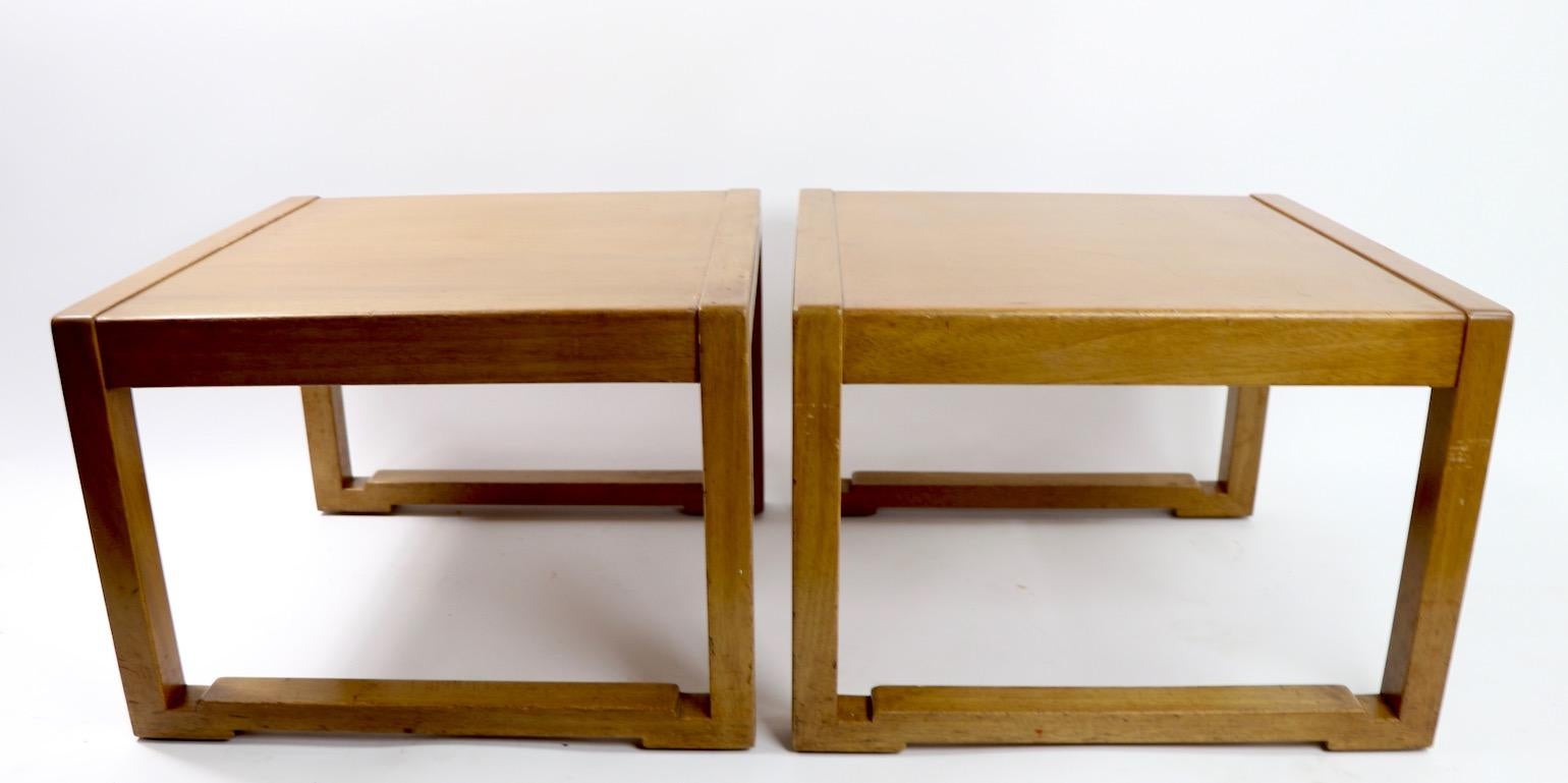 Chic pair of Asia modern style end tables designed by Edward Wormley for Dunbar. Tables are in original estate condition and show some surface wear, including visible veneer fracture to top of one Stand, cosmetic not structural ( pictured ).
Both