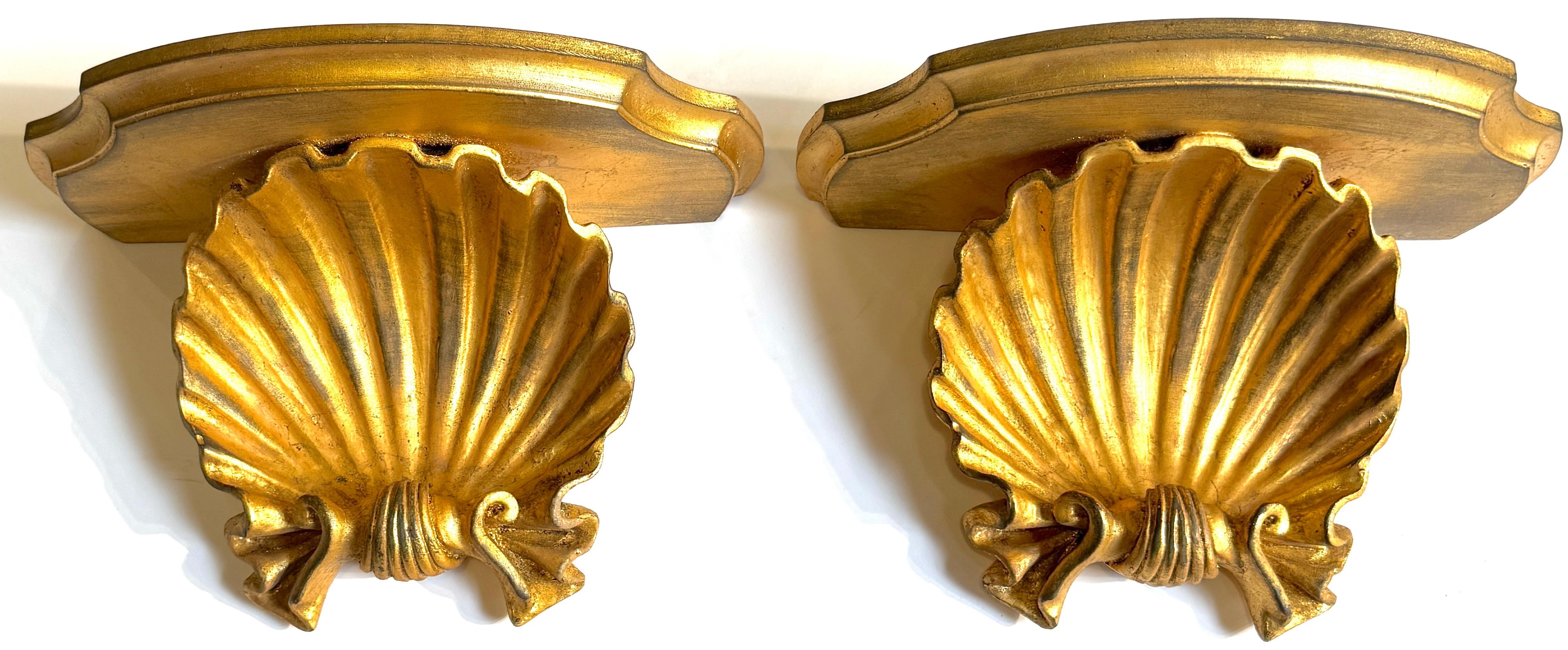 Pair of Italian Giltwood Shell Motif Wall Brackets, Attributed to Palladio, Circa 1960s

A striking pair of Italian giltwood wall brackets or shelves, carved in bold relief with stylized scallop shell motifs, attributed to the celebrated Venetian