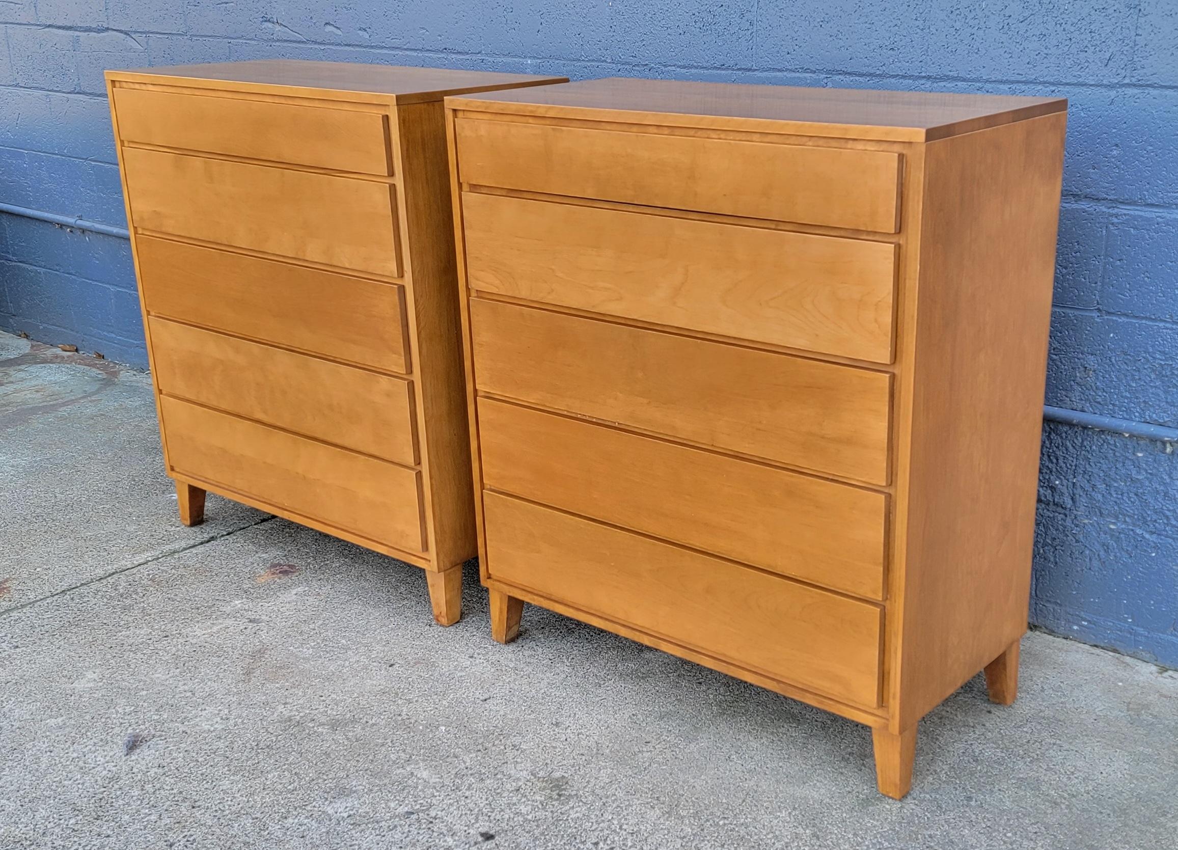 A pair of Mid-Century Modern tall dressers designed by Leslie Diamond for Conant Ball. Circa. 1950. Fine quality crafted in solid maple. Ample storage with 10 drawers. Beautiful wood to interior to drawers that glide easily. Both dressers retail