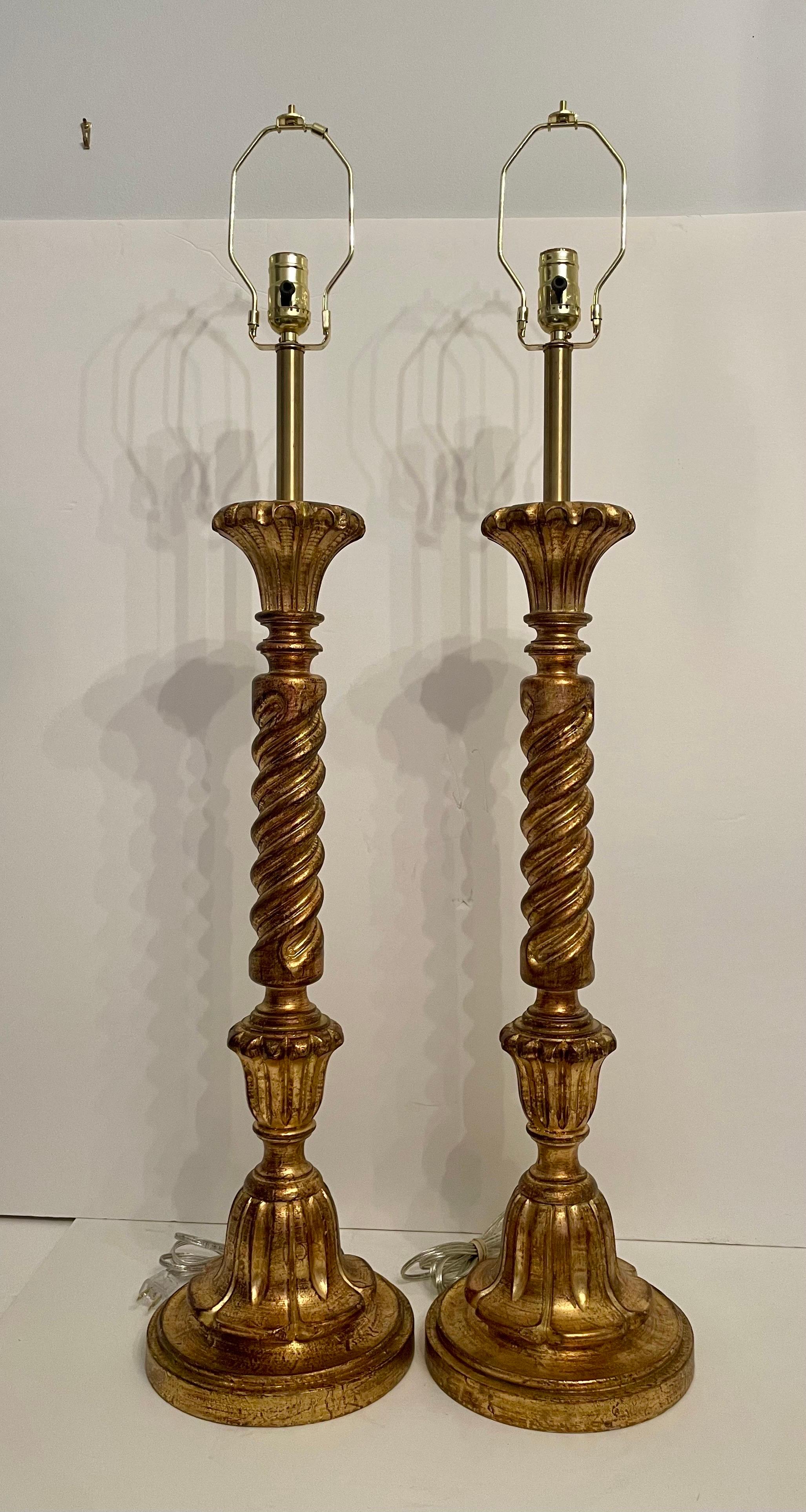 Pair tall carved giltwood and brass Italian lamps. Untouched original finish. Newly wired with 3 way sockets, clear wire and plugs. Measures 35.5