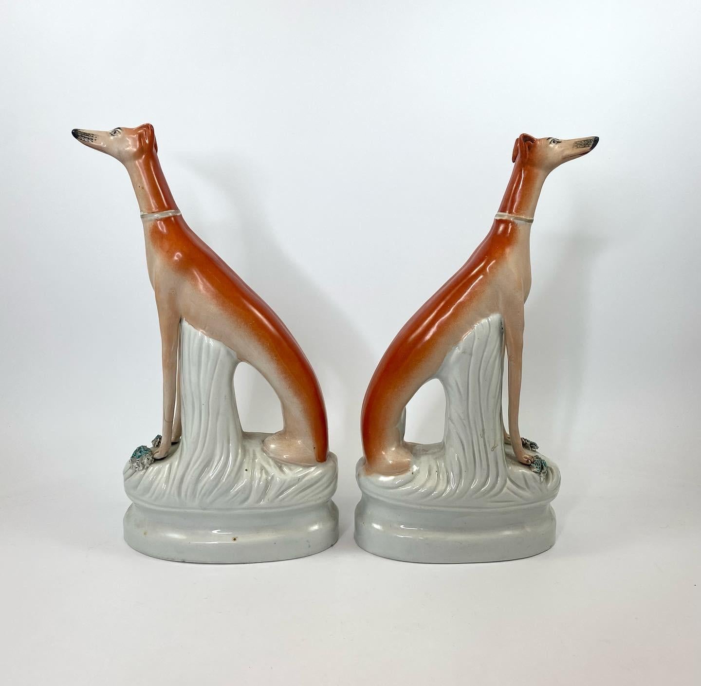 Pair of large Staffordshire pottery Greyhounds, c. 1860. The tall, elegant hounds seated, having separate front legs, with hares to their sides. Set upon oval mound bases, with single gilt lines.
‘A-Z of Staffordshire Dogs. A Potted History’, Clive