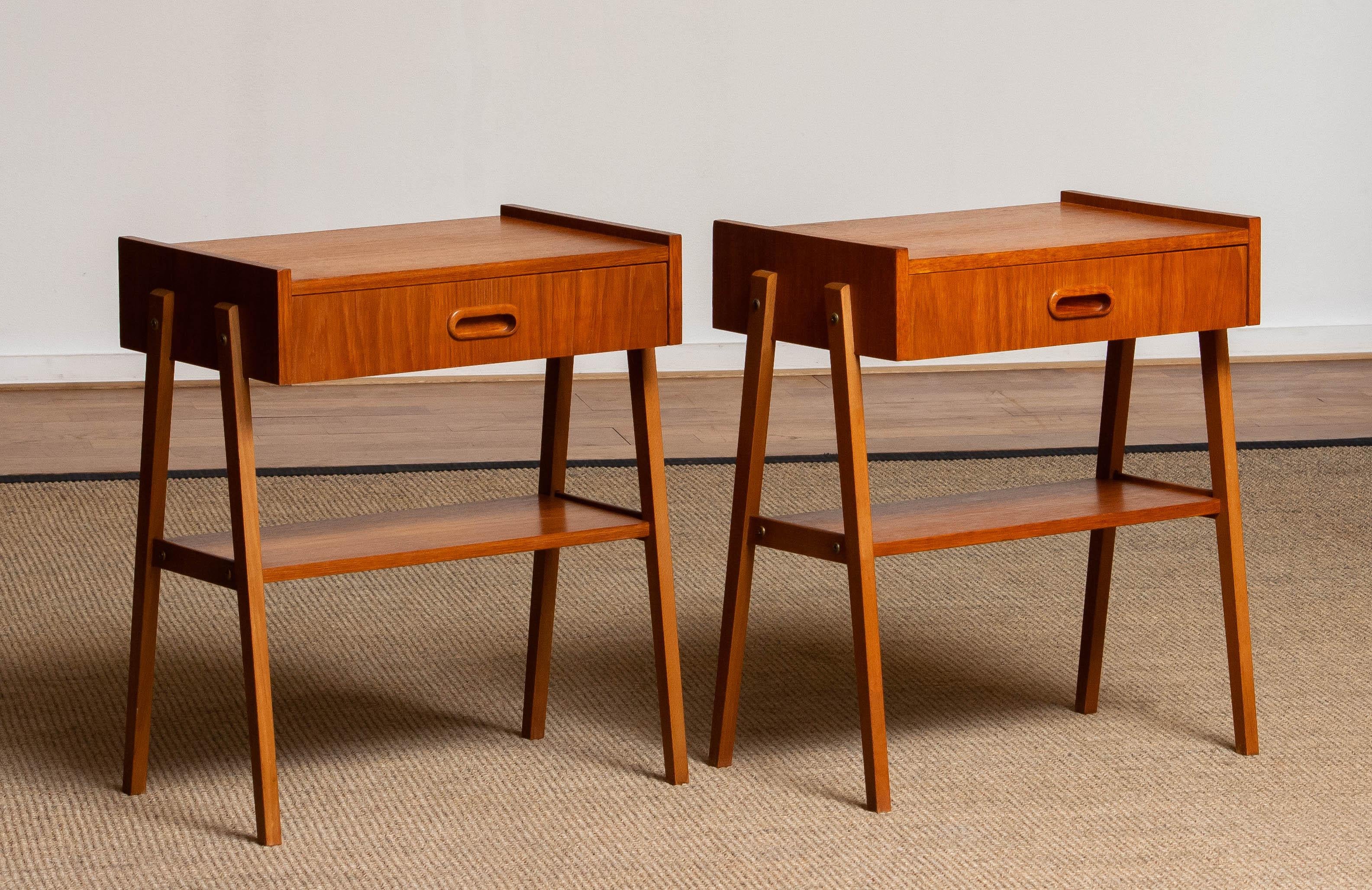 Beautiful set of two nightstands / bedside tables with drawer in teak from the 1950s and made by Ulferts Möbler Sweden. 
The overall condition for both nightstands is good.
Please note that we will replace the inside bottoms of the drawers for new