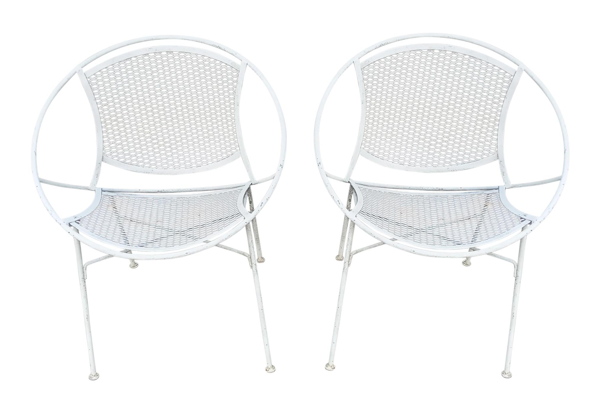 Pair of Salterini Radar chairs in white enameled wrought iron.  
A fine pair of the iconic model designed by Maurizio Tempestini, for Salterini.
Each chair measures 30-inches high x 25-inches wide x 21-inches deep with a seat height of