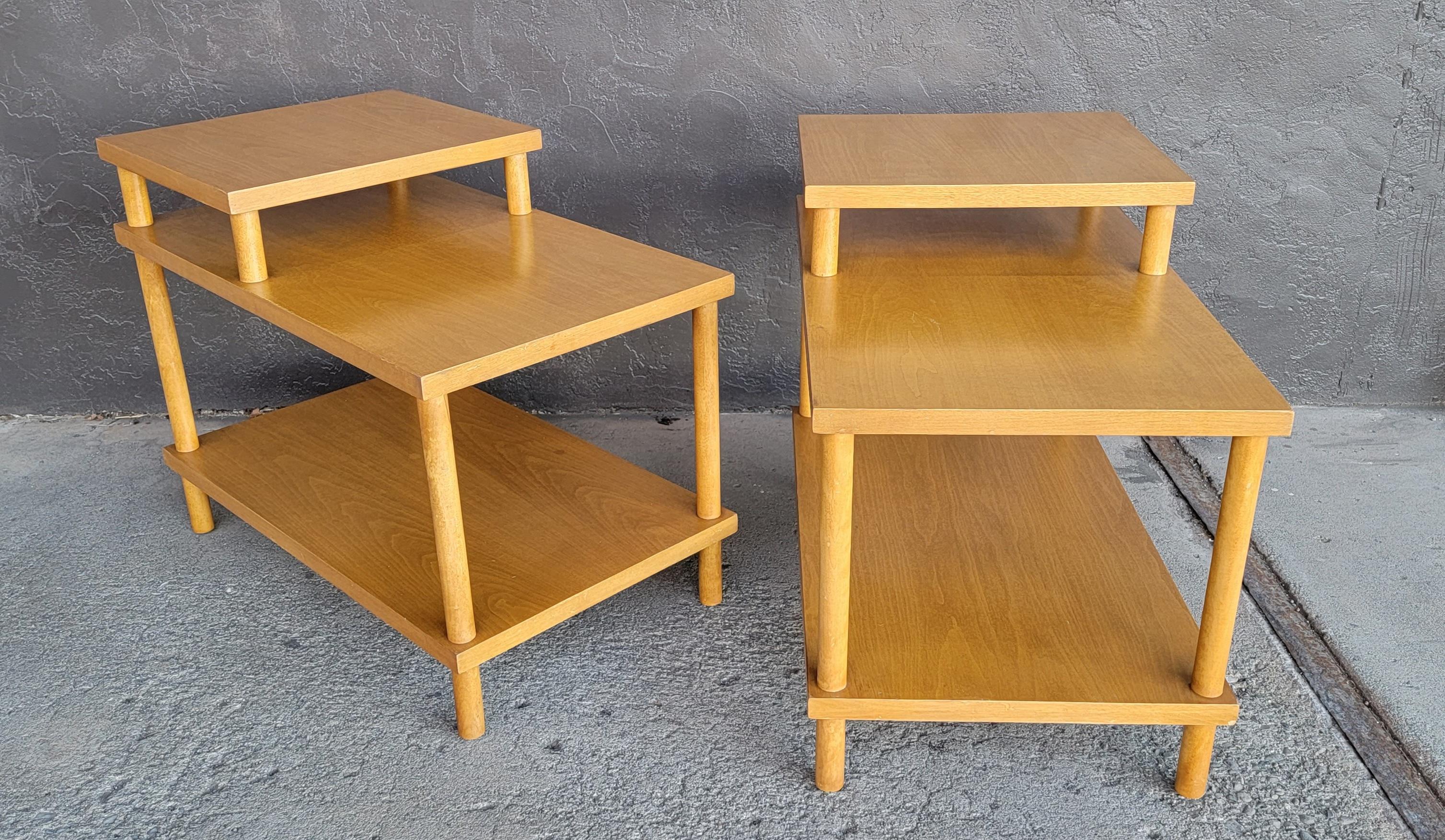 Very nice original finish step-end tables designed by T.H. Robsjohn-Gibbings for Widdicomb Furniture. Circa. 1950's. Both tables retain Robsjohn-Gibbings labels. Three tier tables measuring 24 inches tall, second tier measures 18.25 inches tall.
