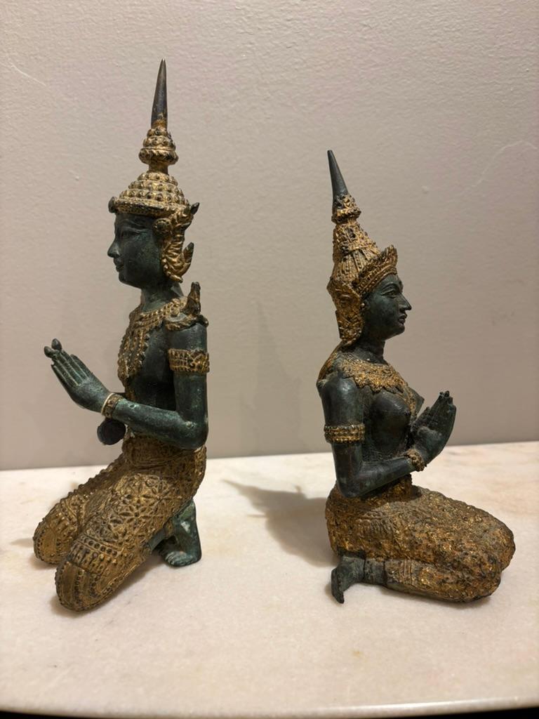 Pair of Thai gilt bronze Buddhist gatekeeper male and female Teppanom kneeling sacred angels. With wonderful verdigris patina and gilt ceremonial costumes and jewellery. 
Teppanom are mythogical angels, part of the Buddhist tradition in