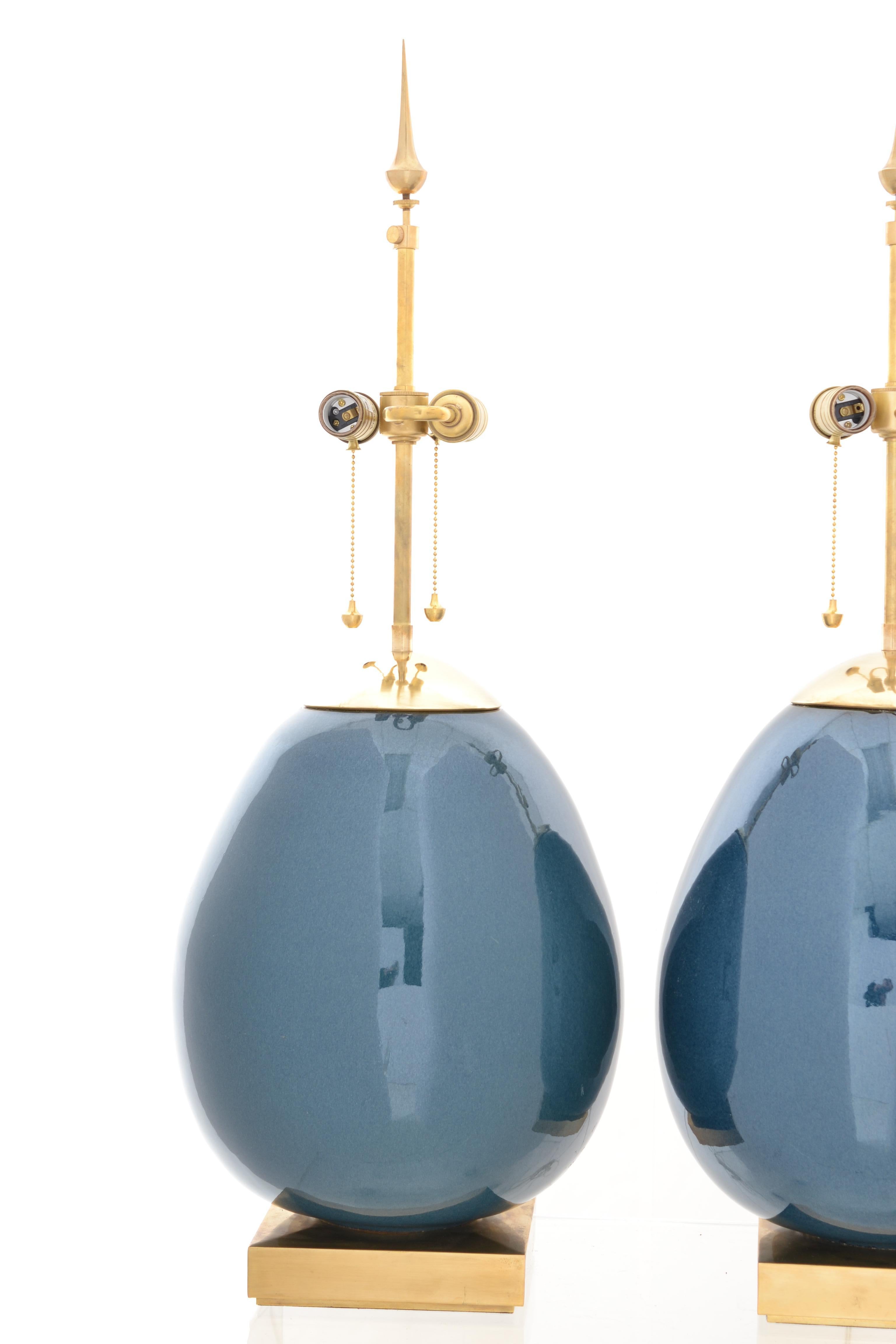 A striking design by noted designer Thomas O'Brien for Visual Comfort & Company Lighting. This pair in a luscious blue with brass fittings. Gently used with no noticeable wear.