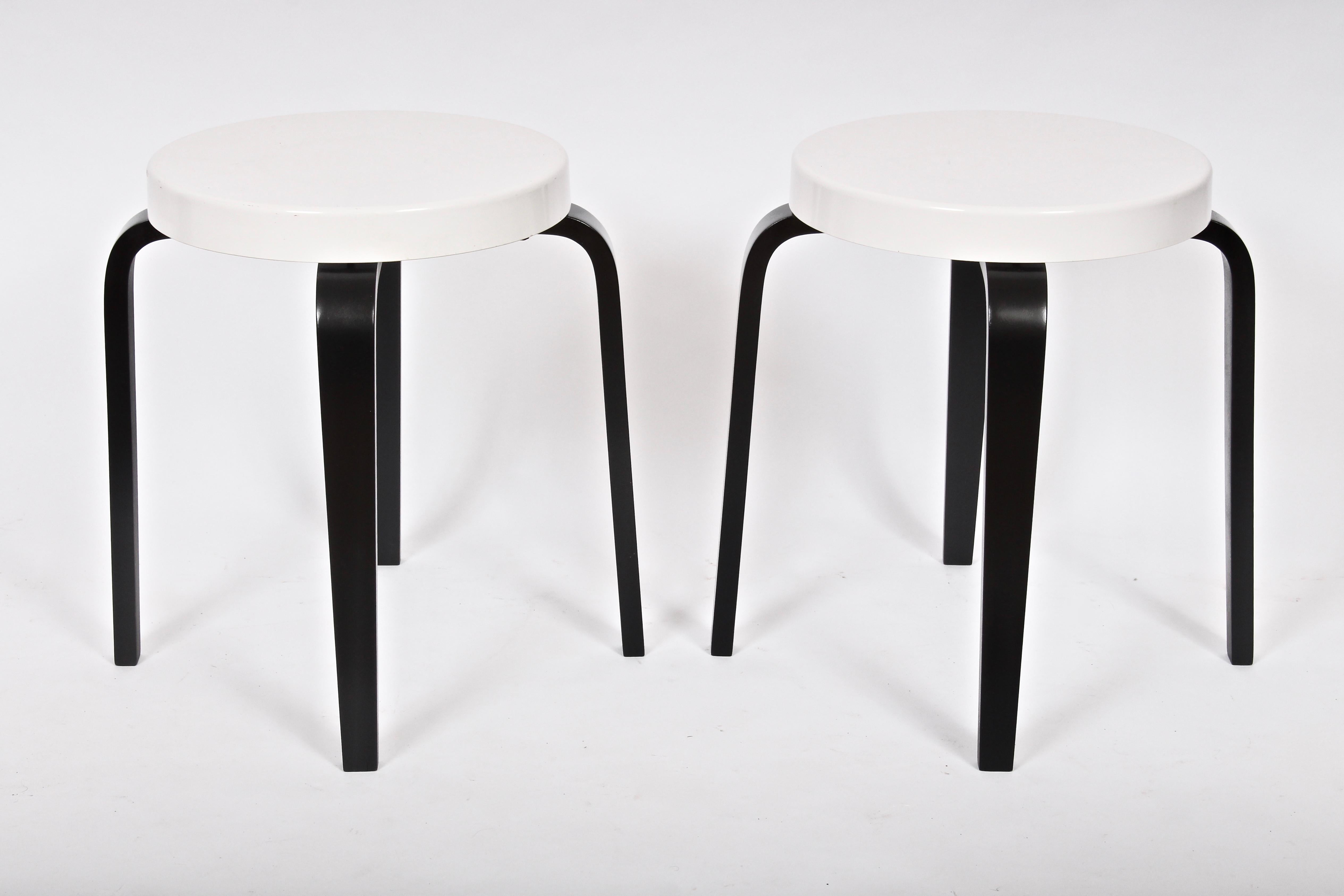 Early pair of Thonet Nesting Tables, Stacking Stools.  Featuring circular White Bakelite 14D seats atop Black, ebonized, bentwood legs.  Attributed to Alvar Aalto. Stackable. Perfect additional seating. Striking. Classic. Timeless. Stamped Thonet to