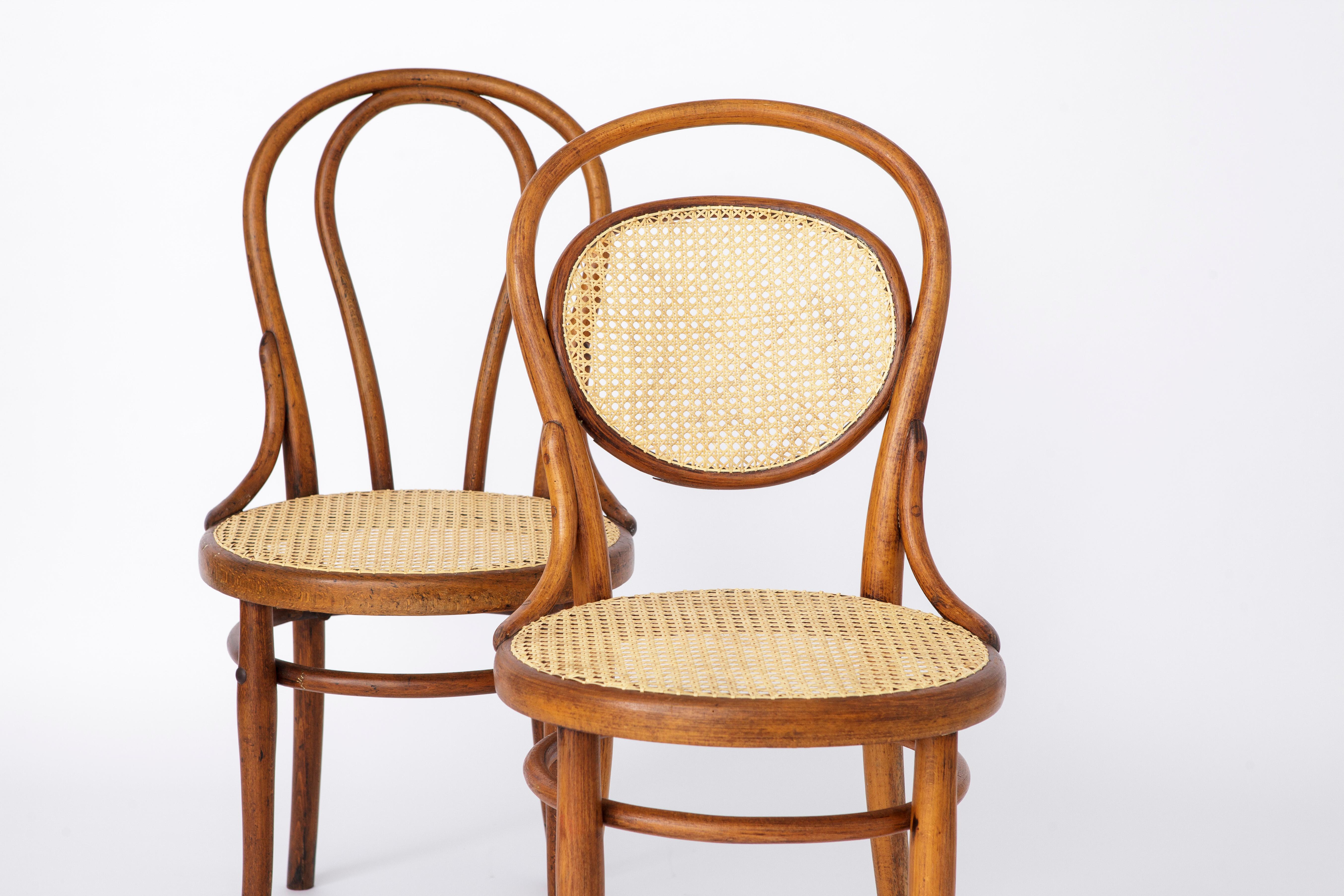 Pair of Thonet chairs, model No. 18 + model No. 215. 
Design by Michael Thonet in 1859. 
Production period approx. 1920-1950s. 

Sturdy beech bentwood chair  frame. Refurbished and oiled. 
Renewed Danish cane seat. Manufacturer's mark under the