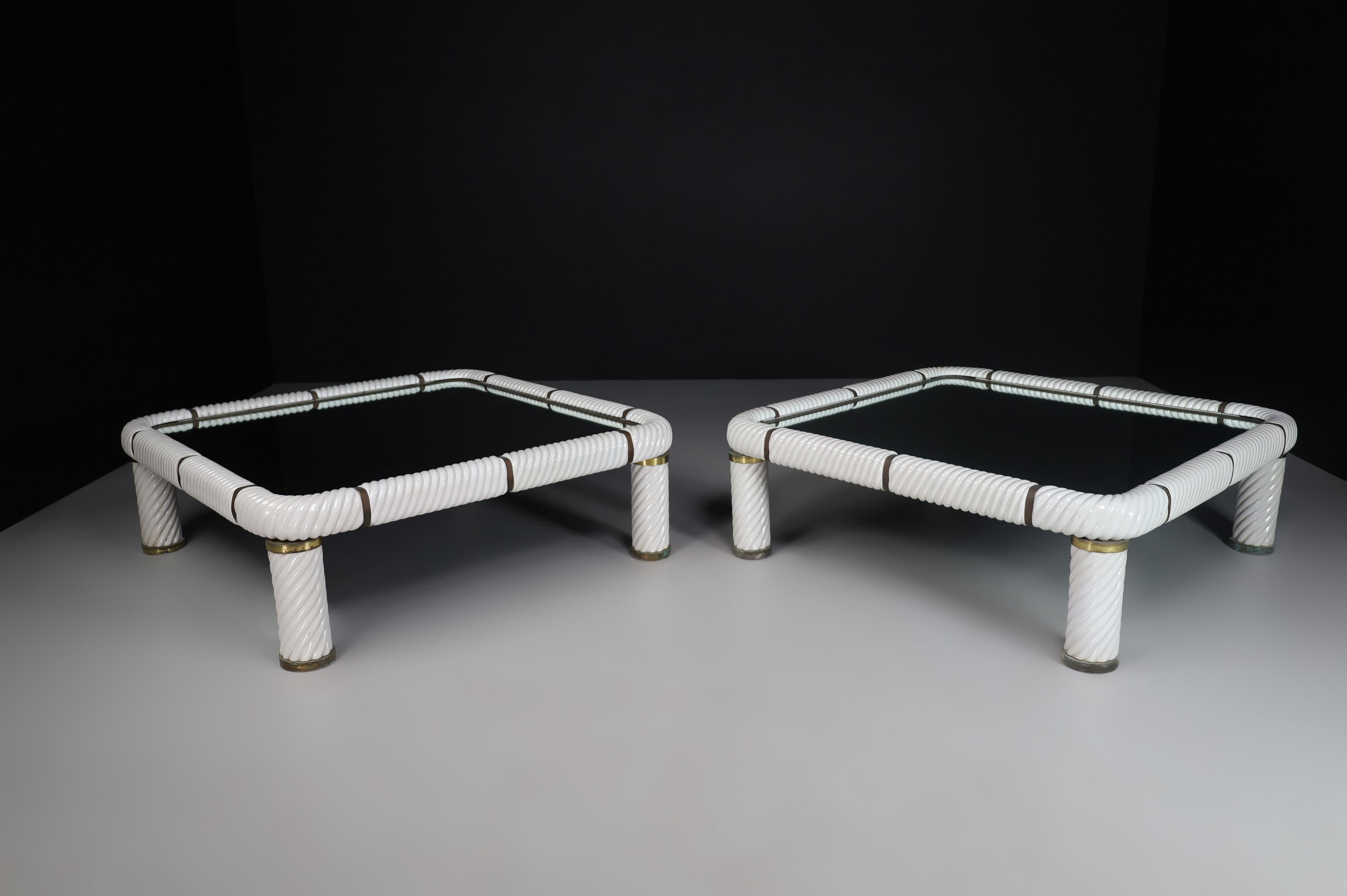 Stunning pair of two large Tommaso barbi white ceramic and brass coffee tables made and designed in Italy 1970s .These tables features one of Barbi's signature techniques, which is porcelain in a spiral form to give this table it's absolute stunning