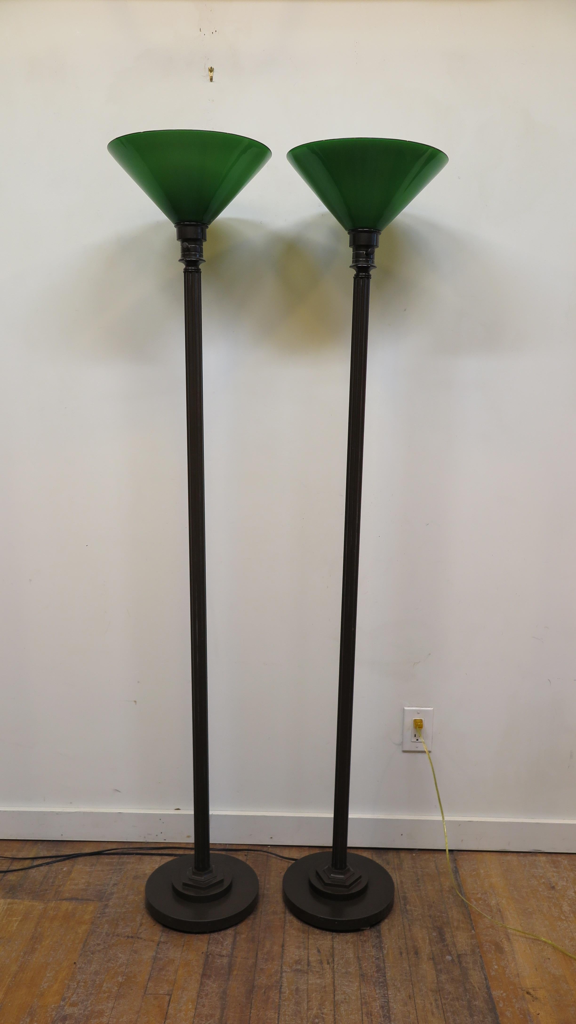 Pair of bronzed metal torchiere floor lamps library style with green glass shades. Late 20th century good quality in very good condition. Lamps have a 3 way switch, accepts LED bulbs.