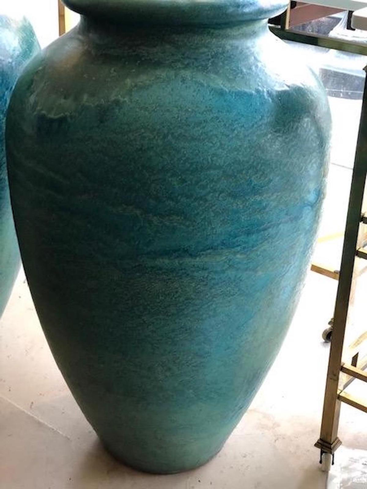 The Galloway terra cotta co founded in Philadelphia at the turn of the century, created these jars in the 1920s exquisite shades of turquoise. Very large scale measuring 36 inches tall. Drainage spout near bottom rim.