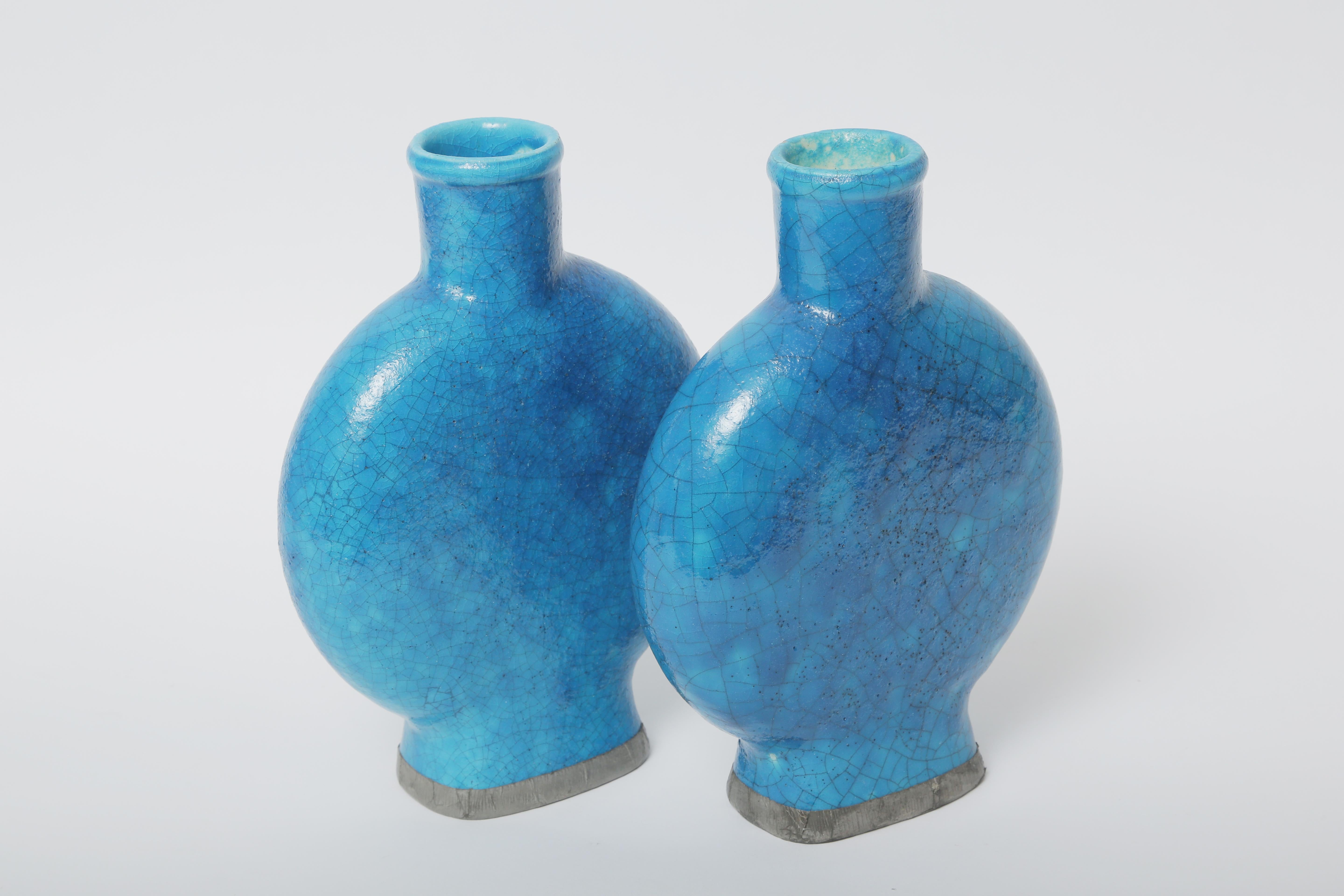 A rare pair of Edmond Lachenal turquoise blue volcanic glazed ceramic vases in wonderful antique condition. Edmond Lachenal (1855-1948) was considered an innovator and a pivotal figure in the Art Nouveau Ceramic Art Circle. In 1899 at the World's