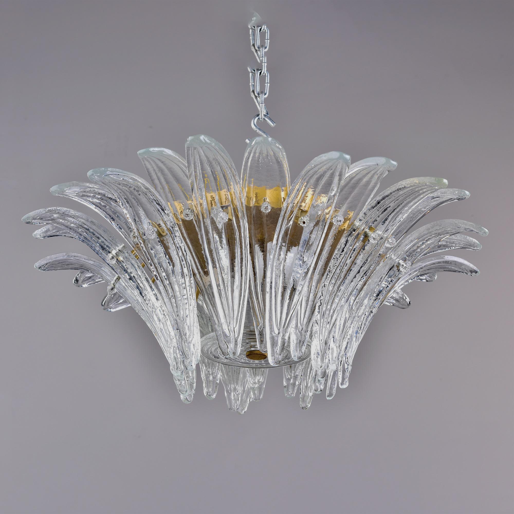 Circa 1970s pair of Venini flush mount fixtures feature curved, leaf shaped Murano glass elements arranged in an overlapping, flared circular pattern. Each fixture has two standard sized sockets. New wiring for US electrical standards. Sold and